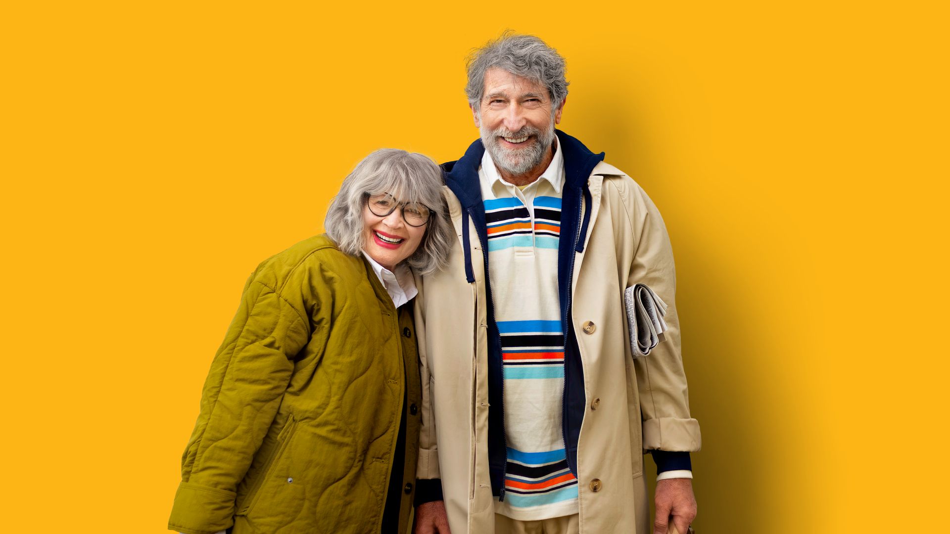 Resident couple smiling at camera in autumn clothes