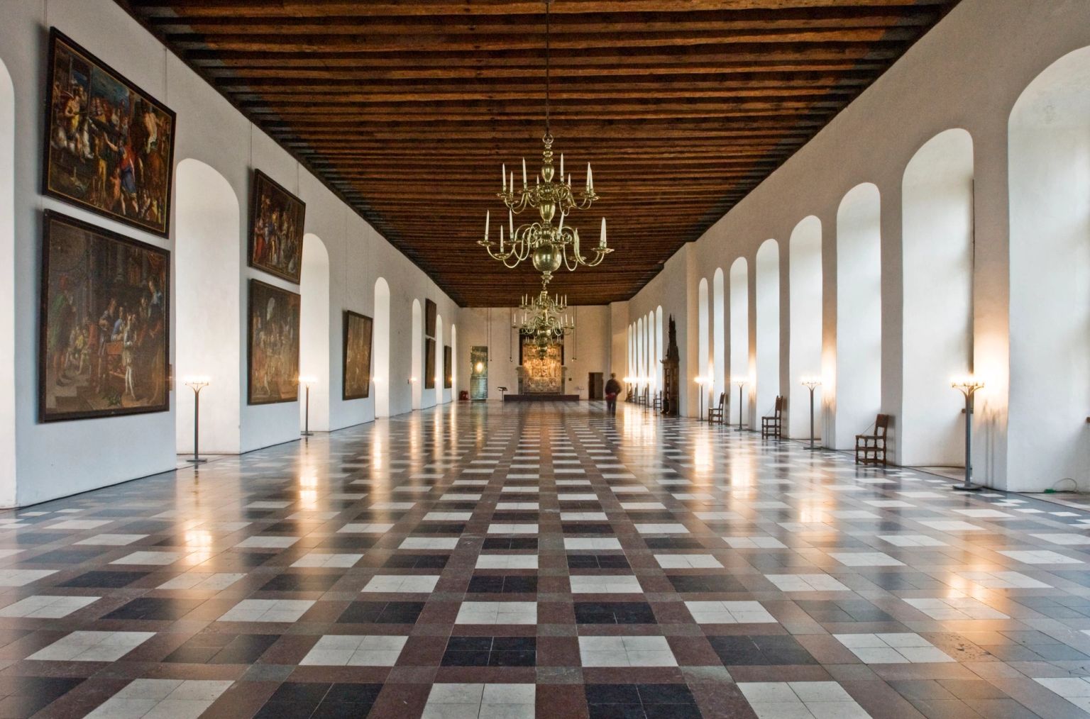 Large dance hall with paintings and chandeliers