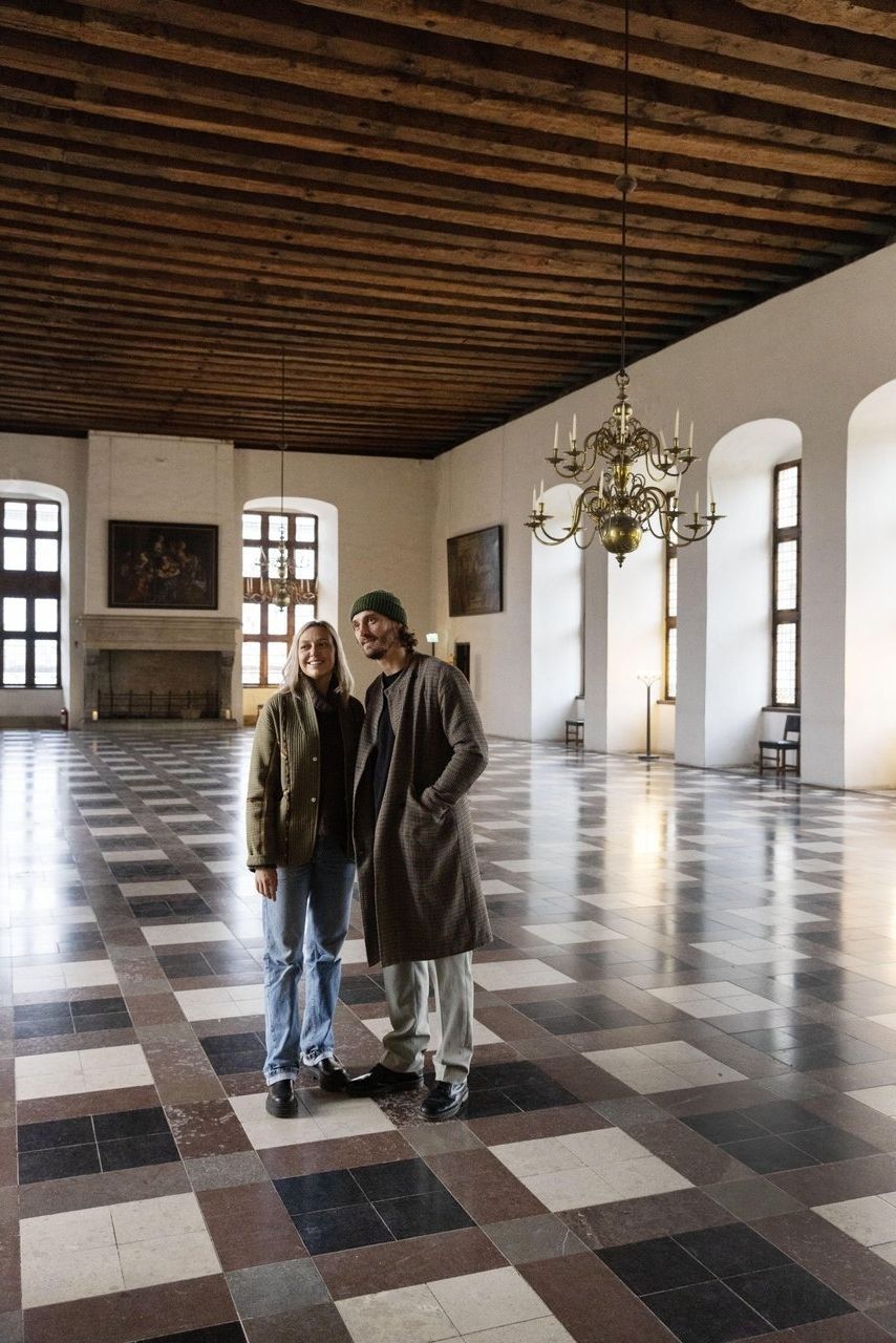 Two people walking and looking in the great dance hall