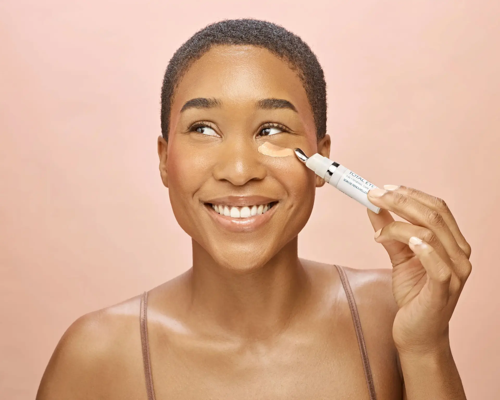 Applying a skincare product underneath the left eye
