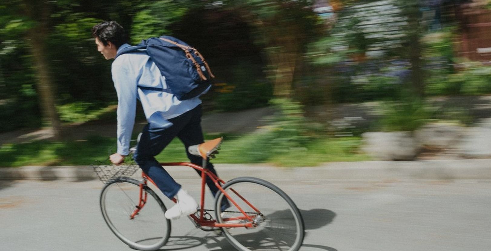 A person waking away wearing Herschel backpack