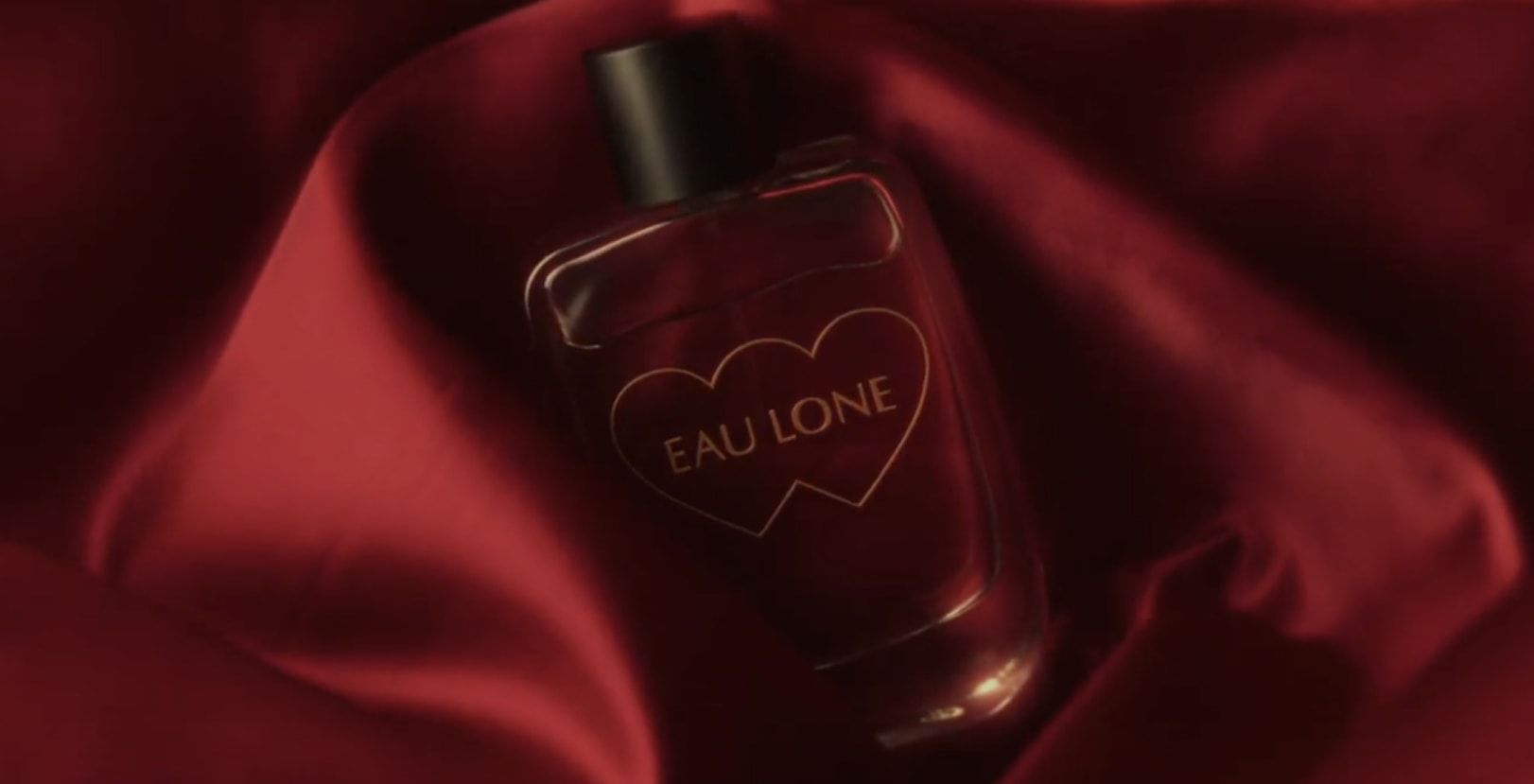 Masked figure with glowing heart-shaped eyes; text reads “Romance is dead – Heart Eyes.”