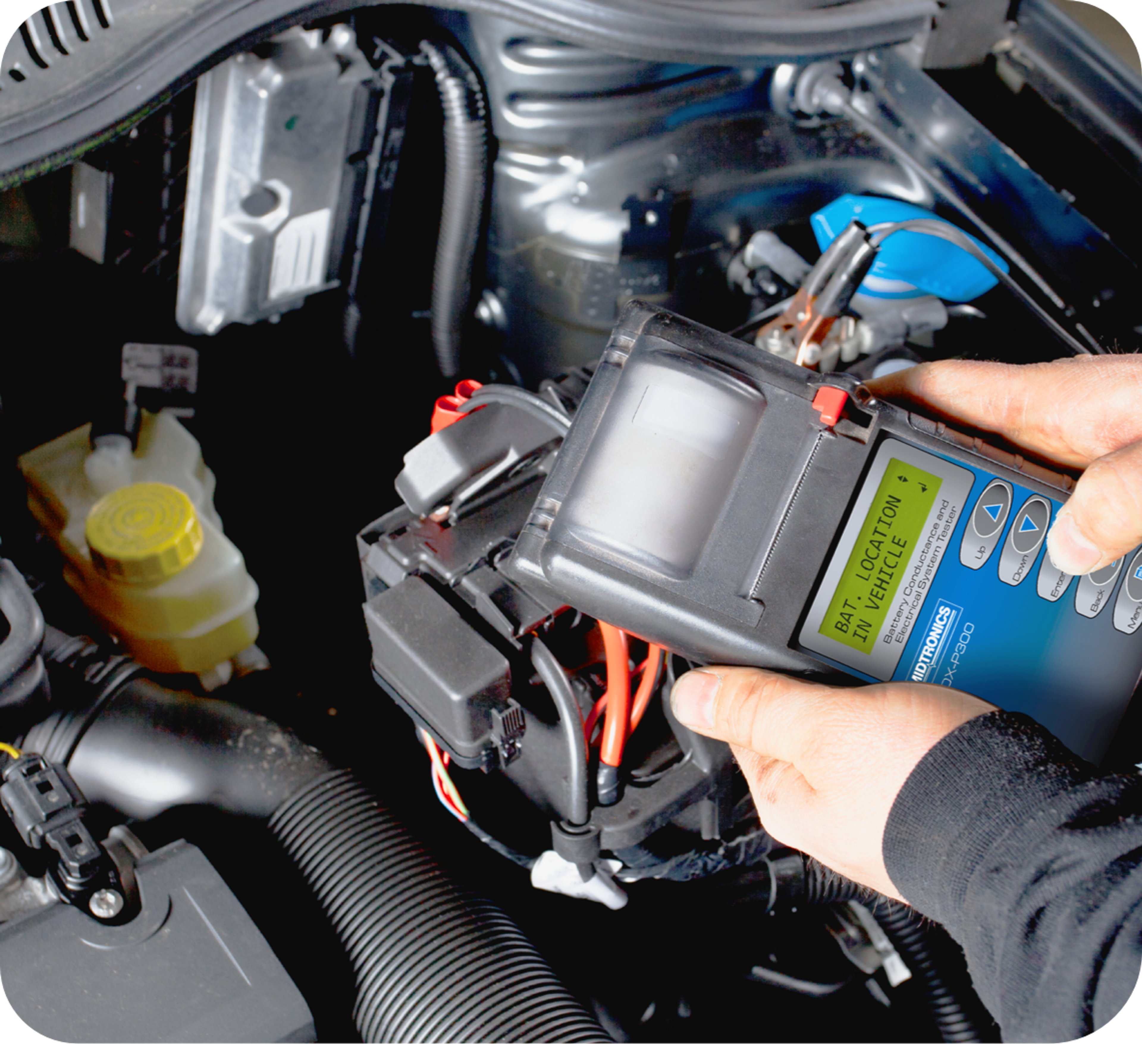 Picture of man holding  a hand held battery tester