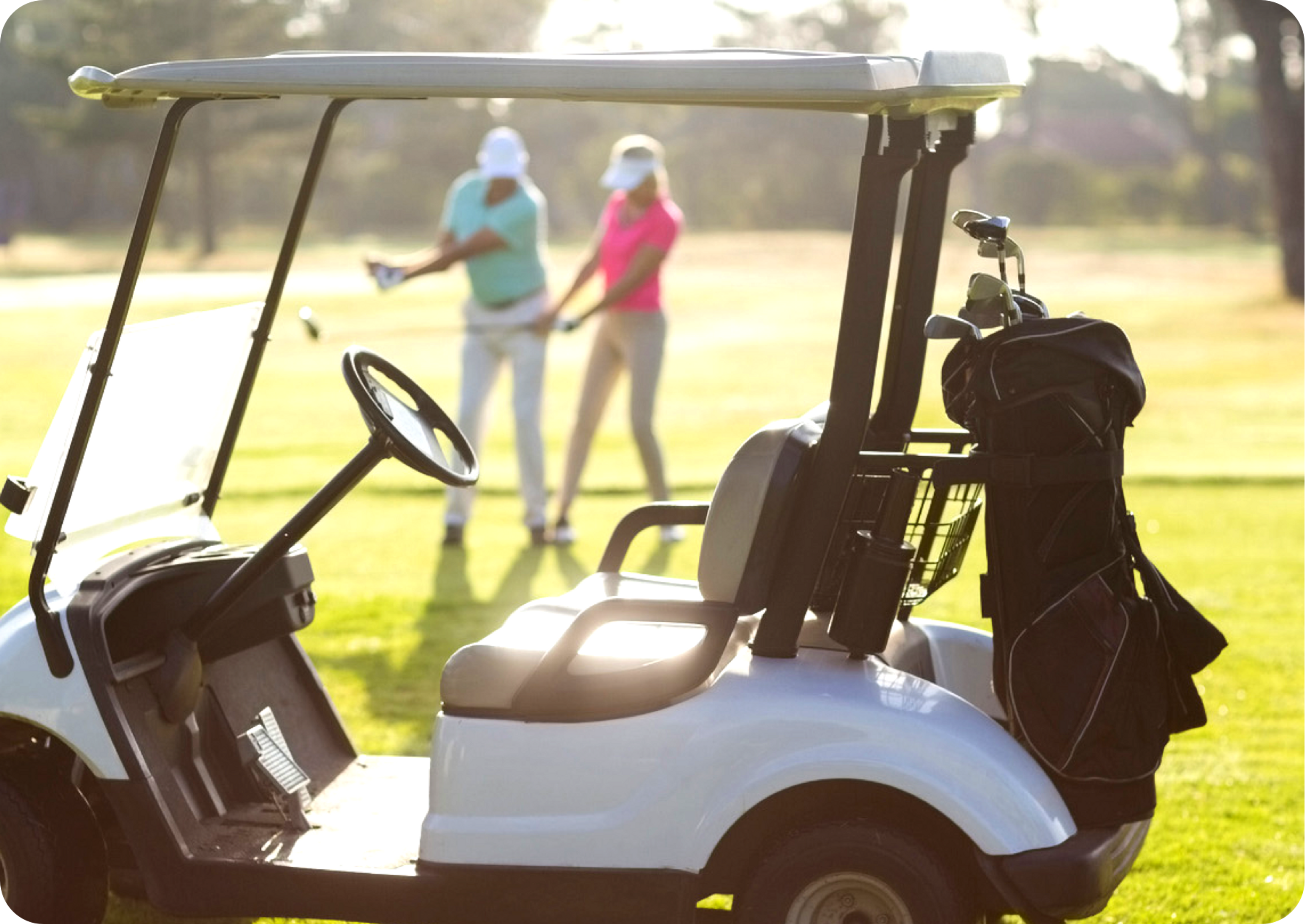 Picture of a white golf cart with a female and male golfer in the image background