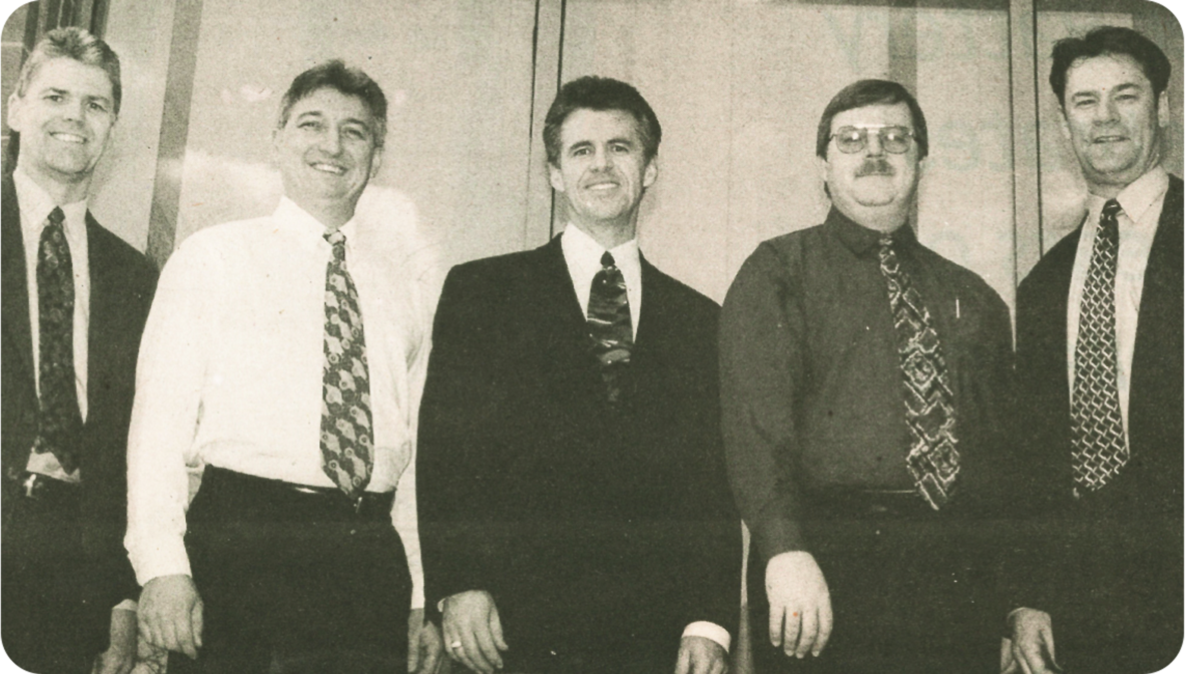 Vintage black and white photograph of 5 men wearing dress shirts and suits