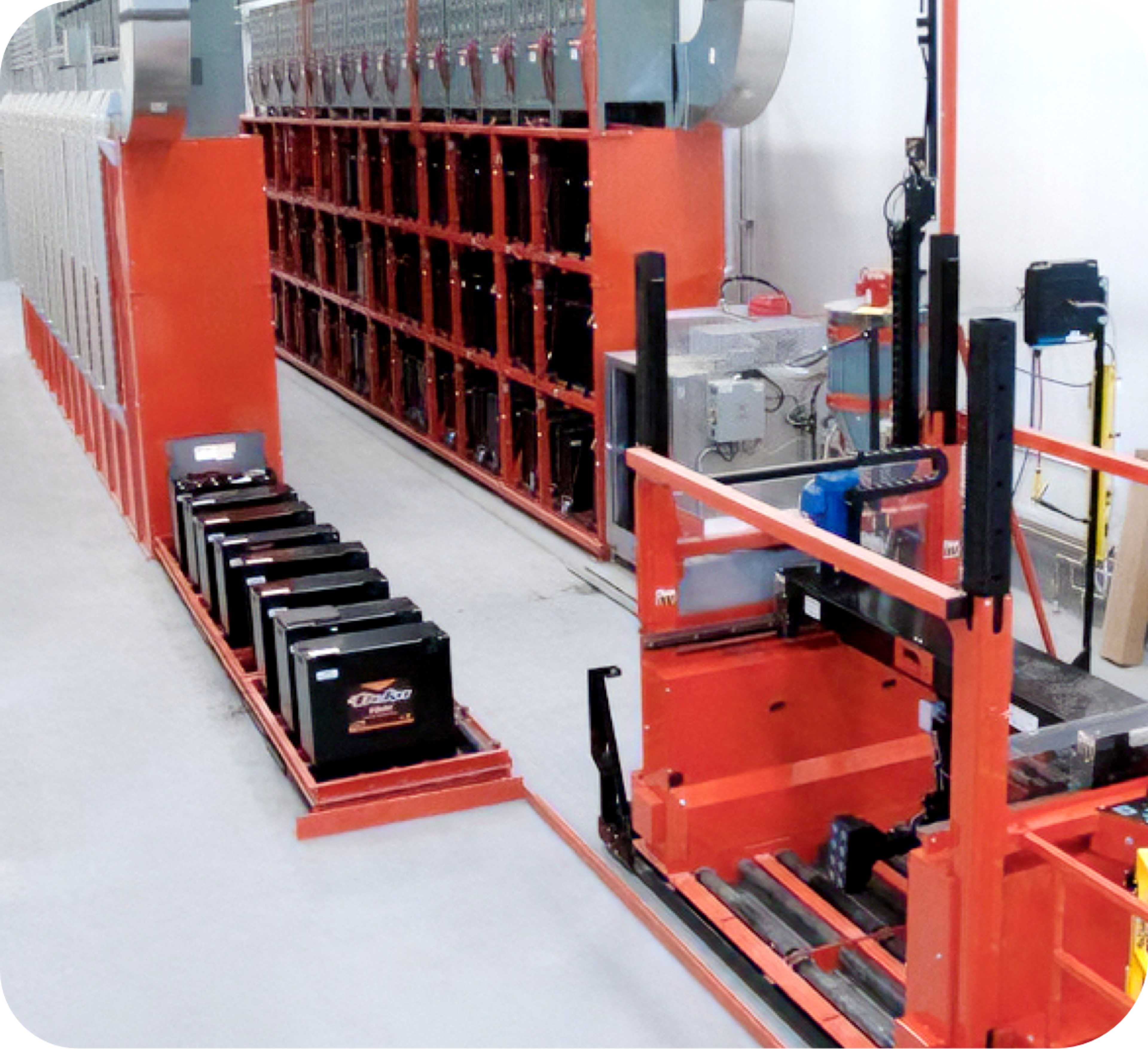 Picture of storage room with orange shelves and car batteries