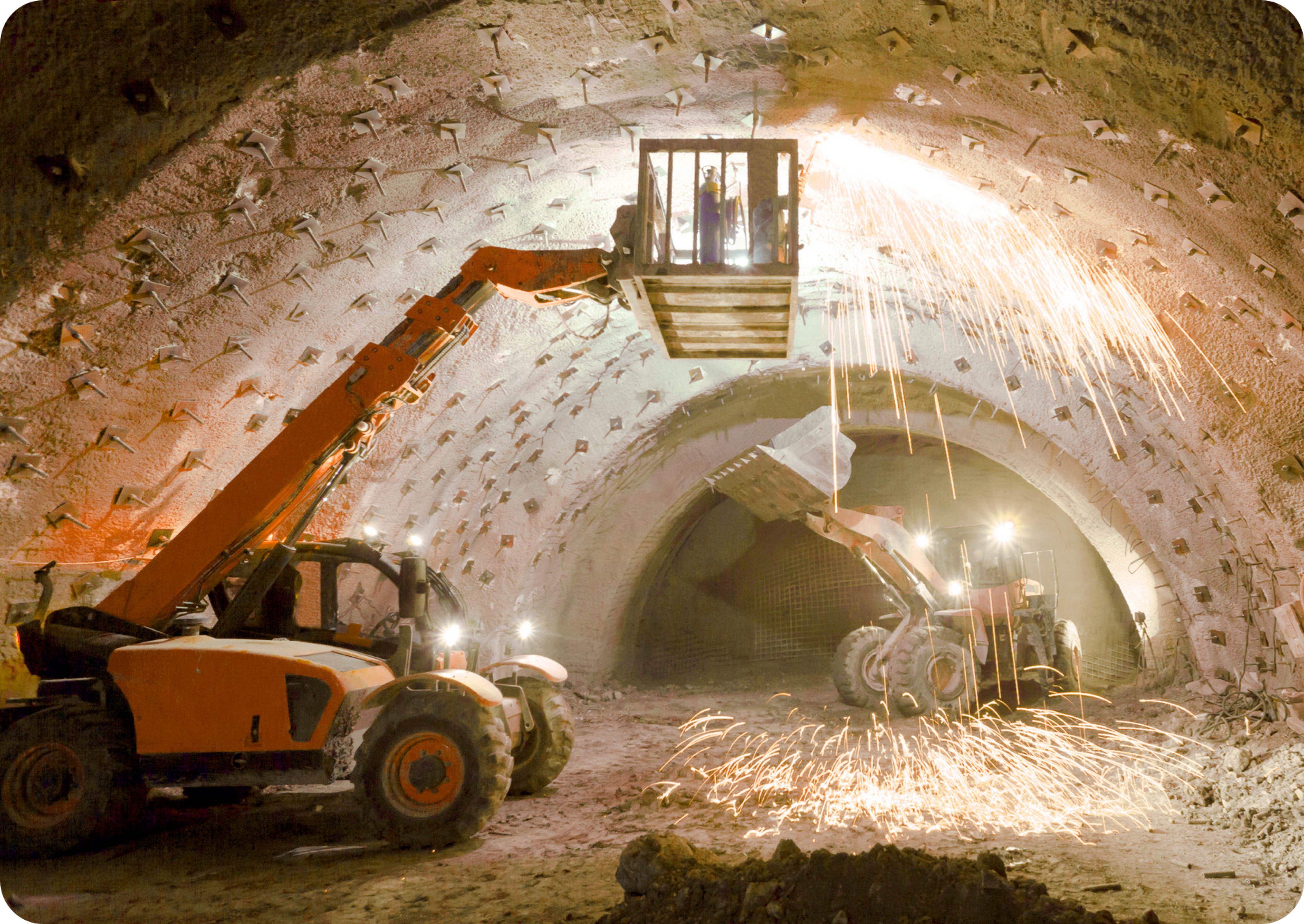 Picture of two orange and black mining trucks and two men operating them