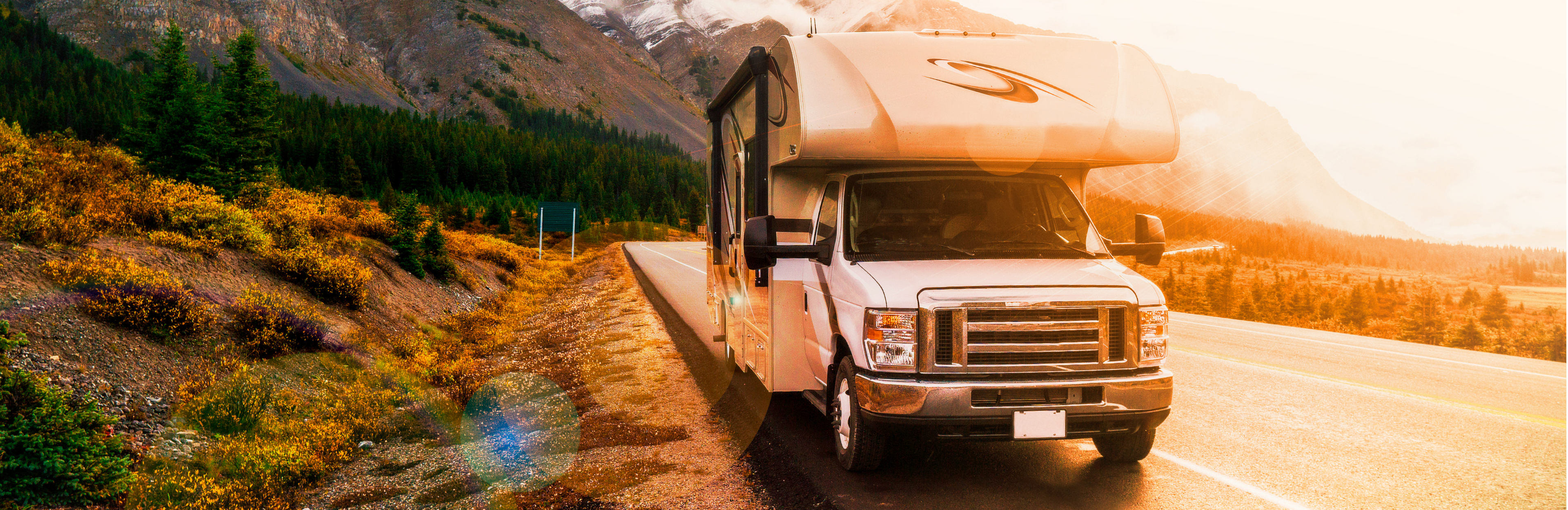 Picture of RV on a sunset road and boreal forest landscape