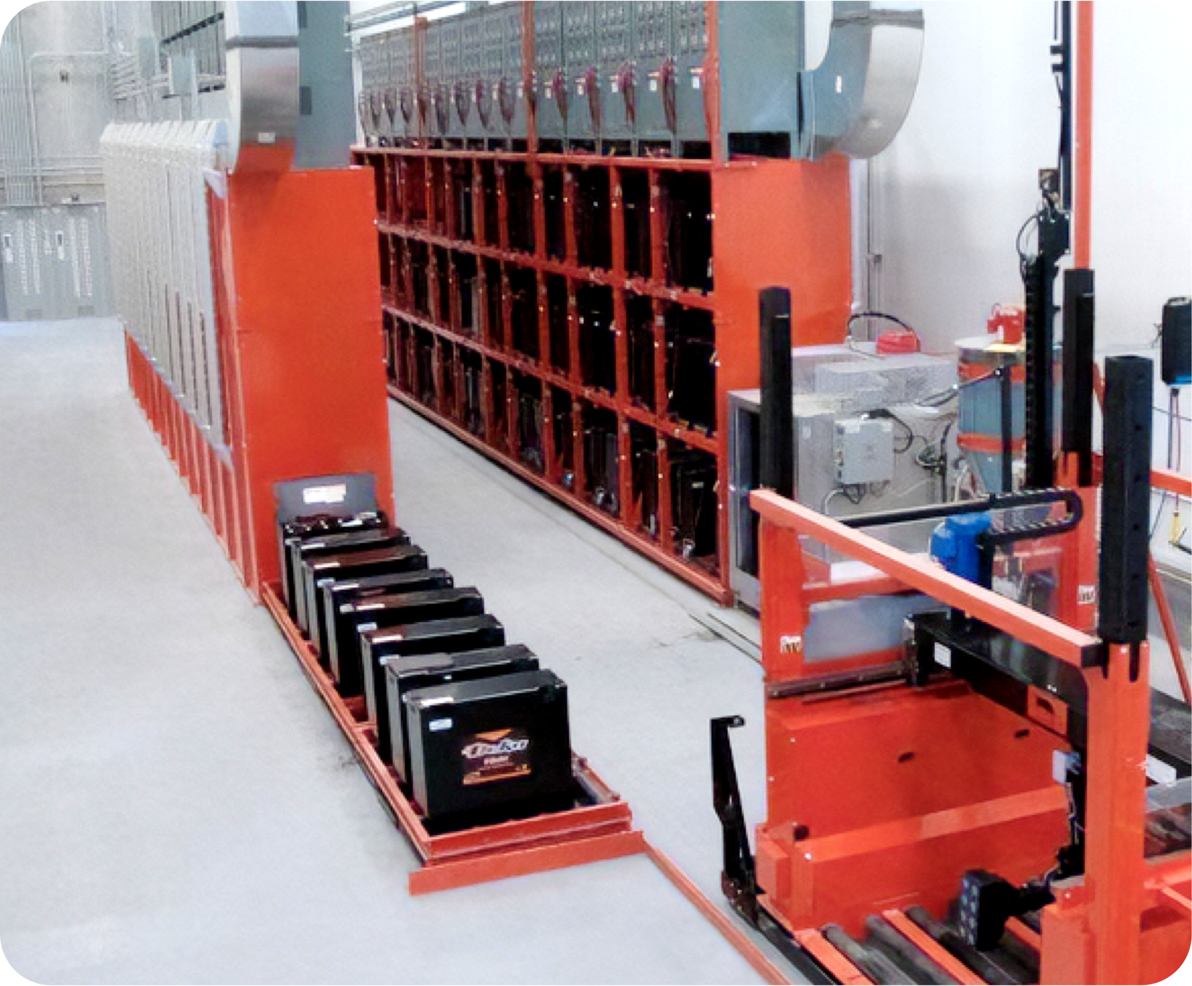 Picture of storage room with orange shelves and car batteries