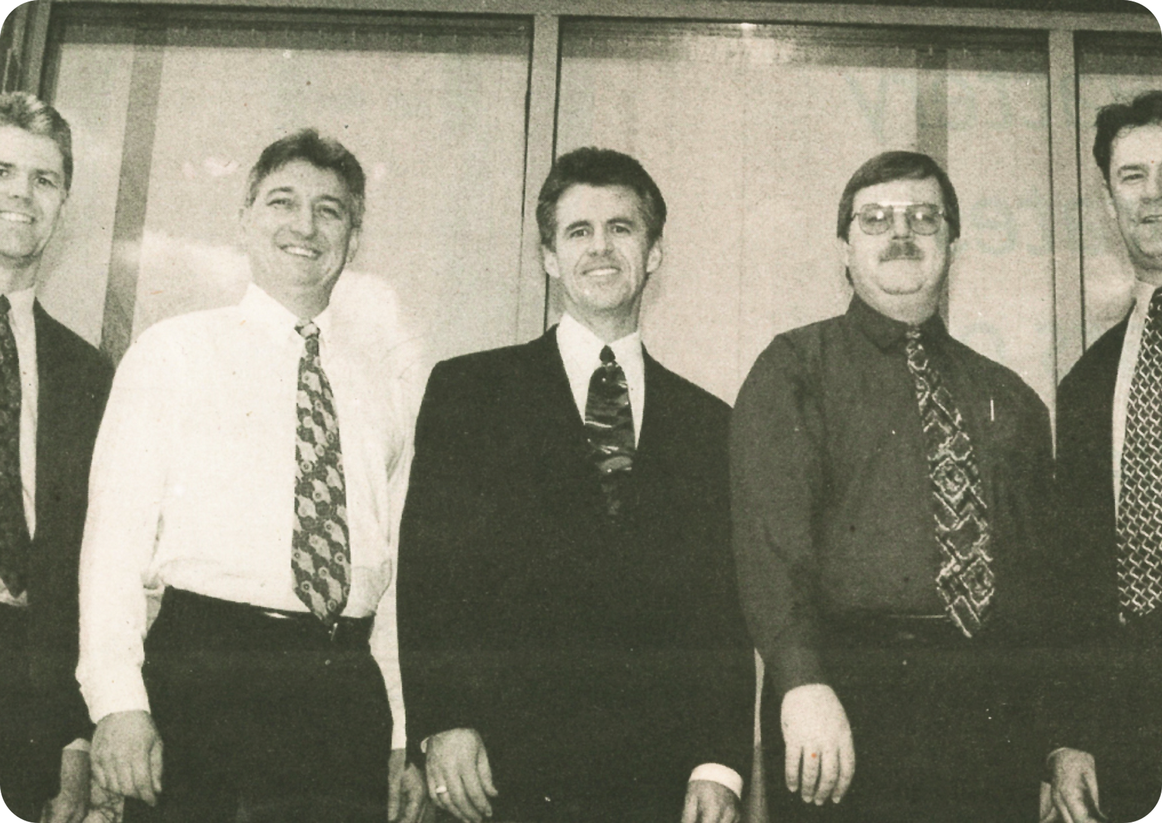 Vintage black and white photograph of 5 men wearing dress shirts and suits