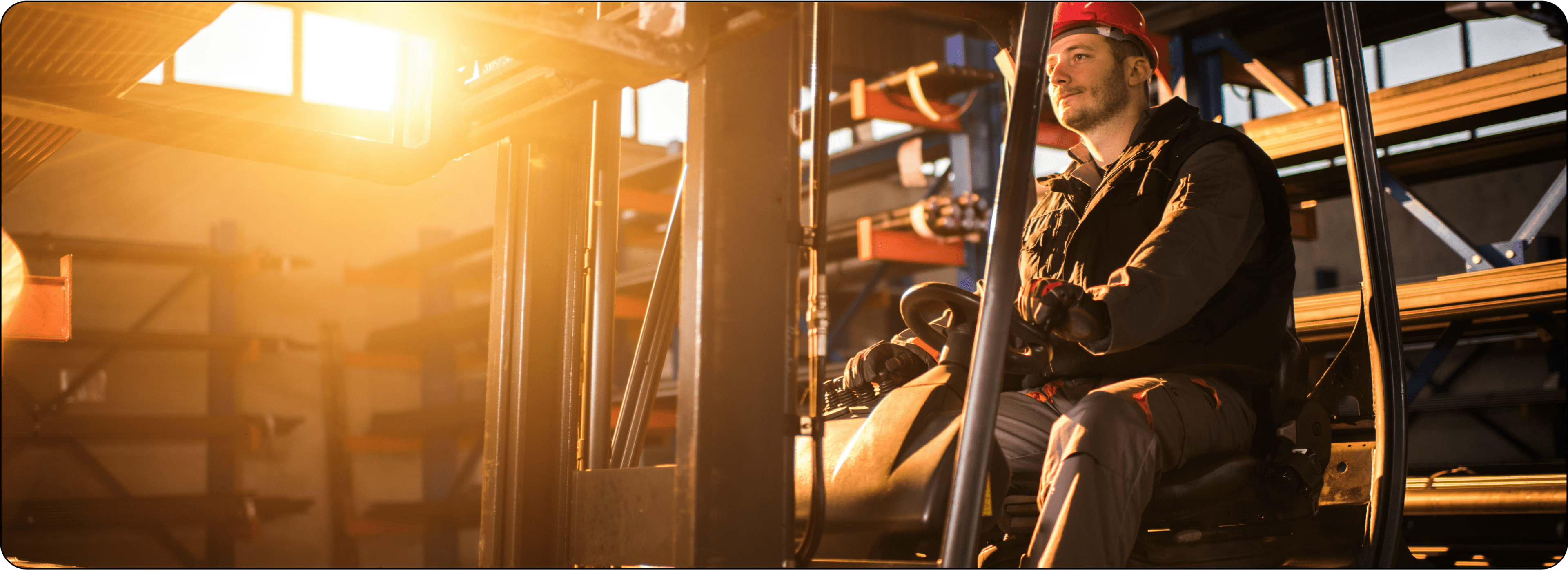 Photo of man wearing a hard hat operating a forklift