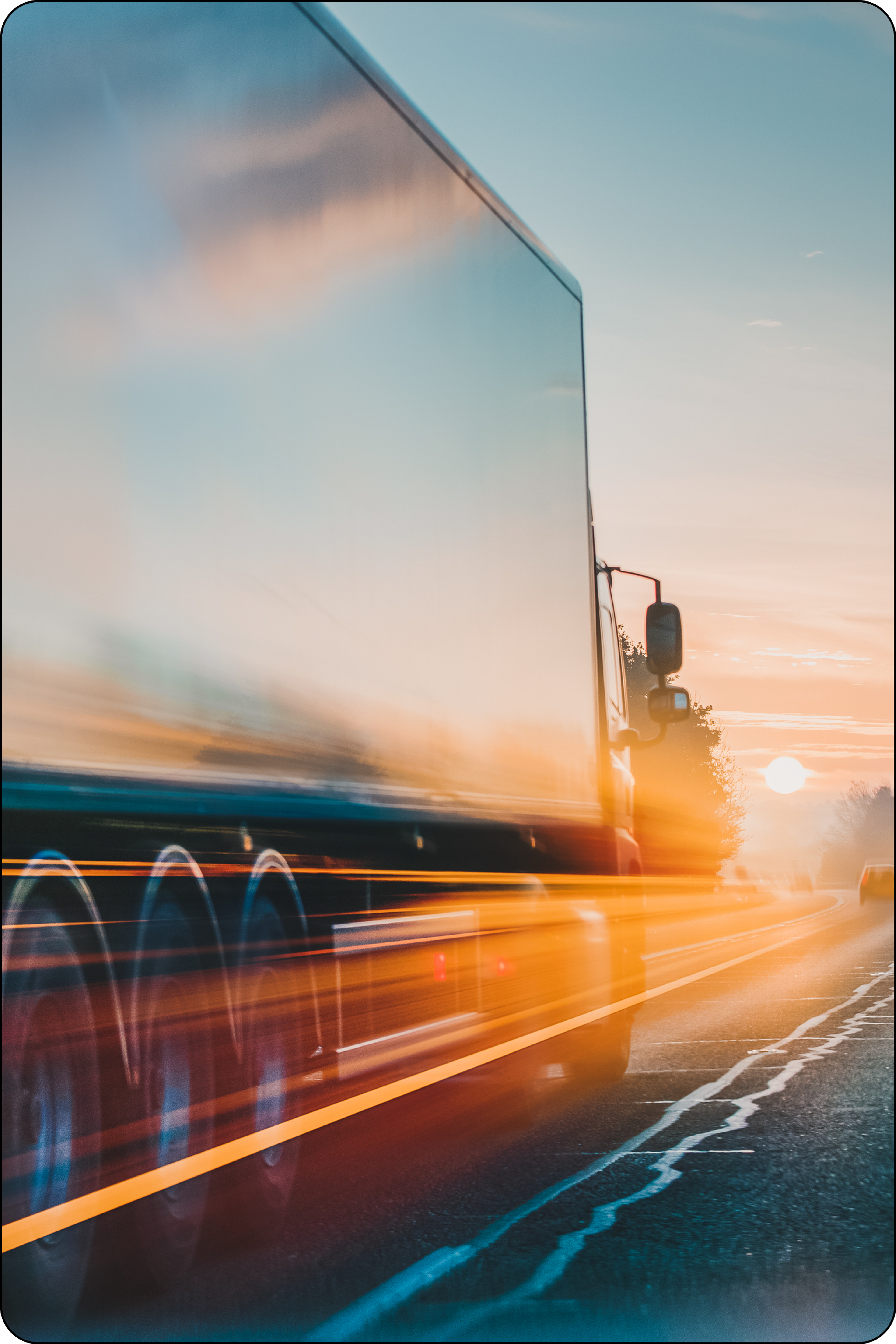 Photo of transport truck and a car on a highway with light speed flares