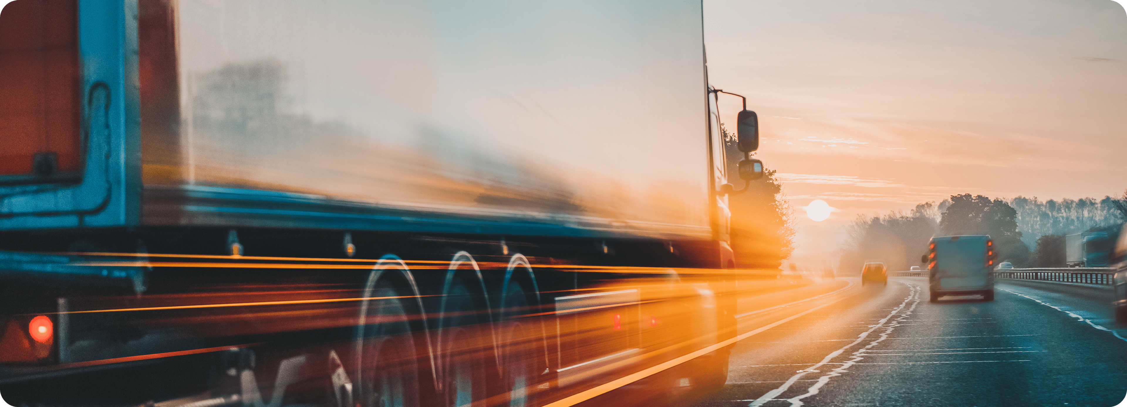 Photo of transport truck and a car on a highway with light speed flares