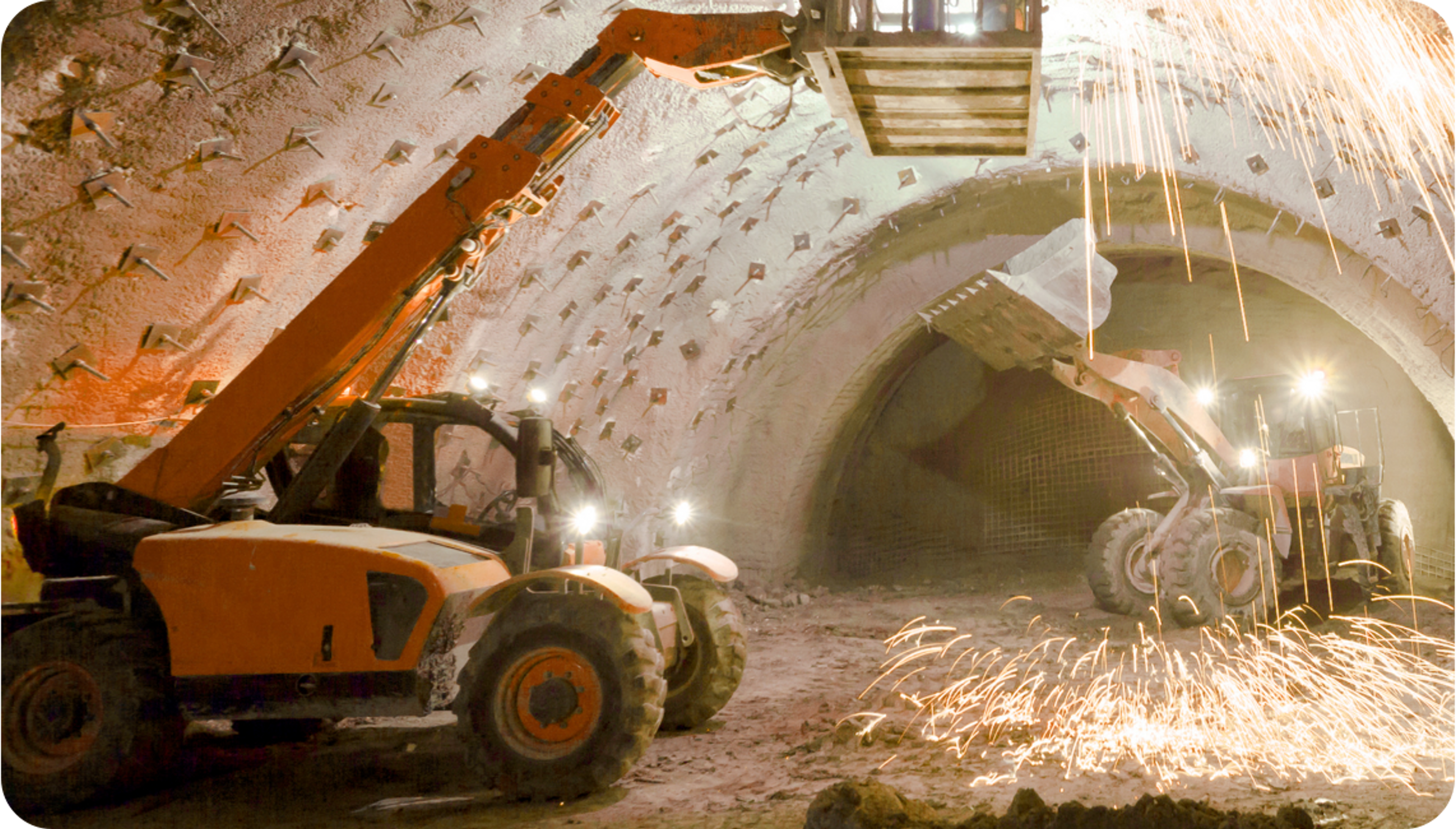 Picture of two orange and black mining trucks and two men operating them