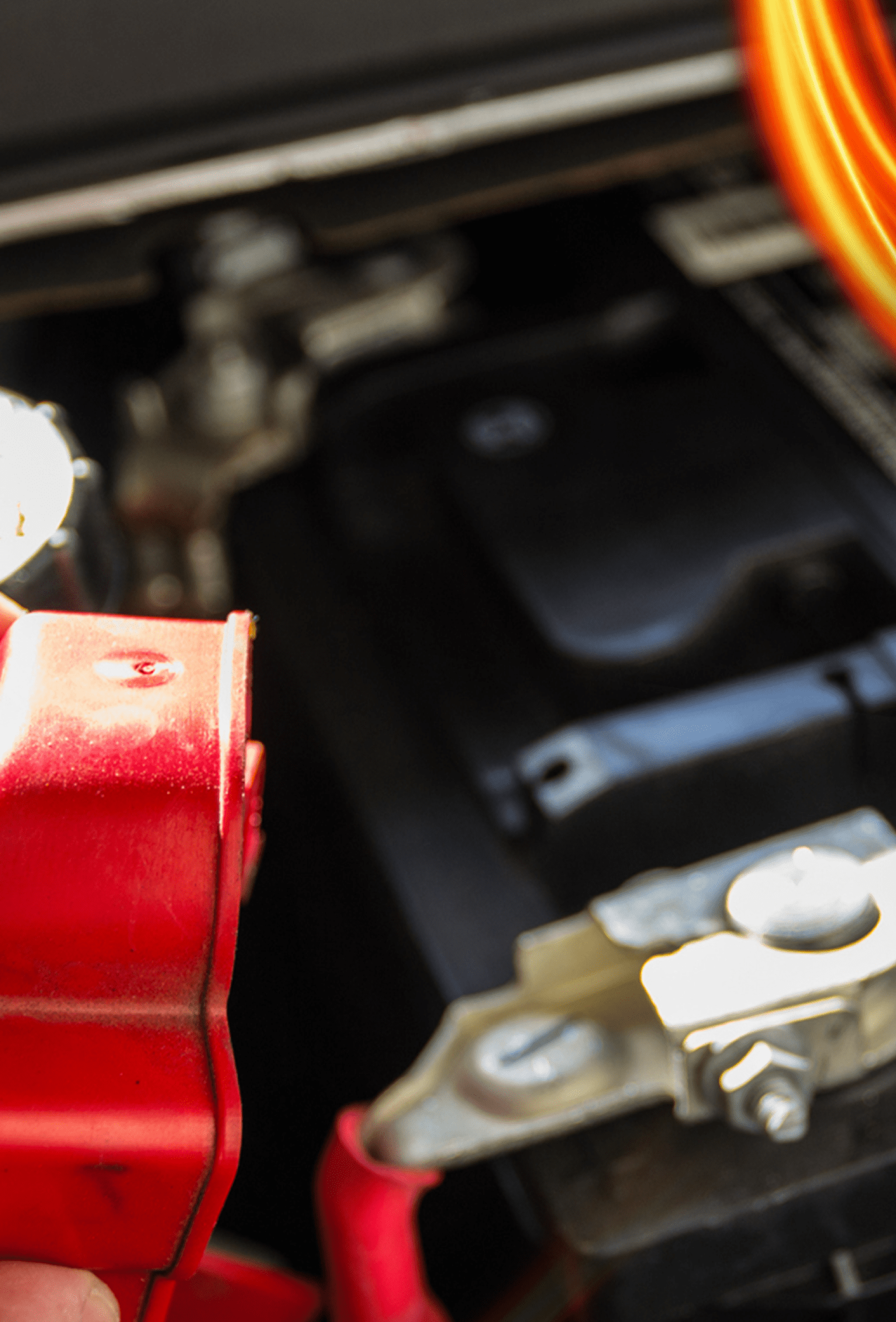 Picture of a man's hand handling a car battery