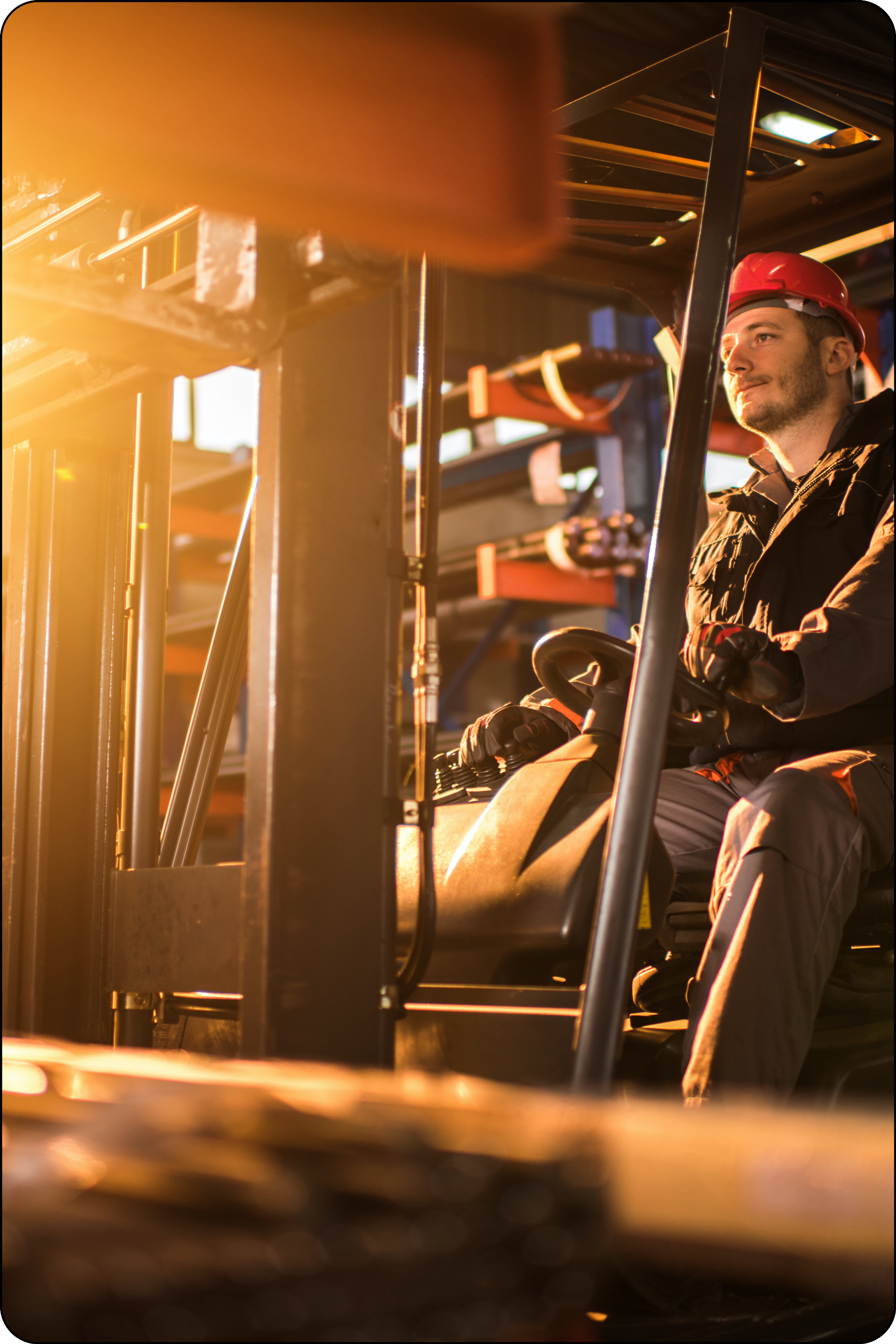 Photo of man wearing a hard hat operating a forklift