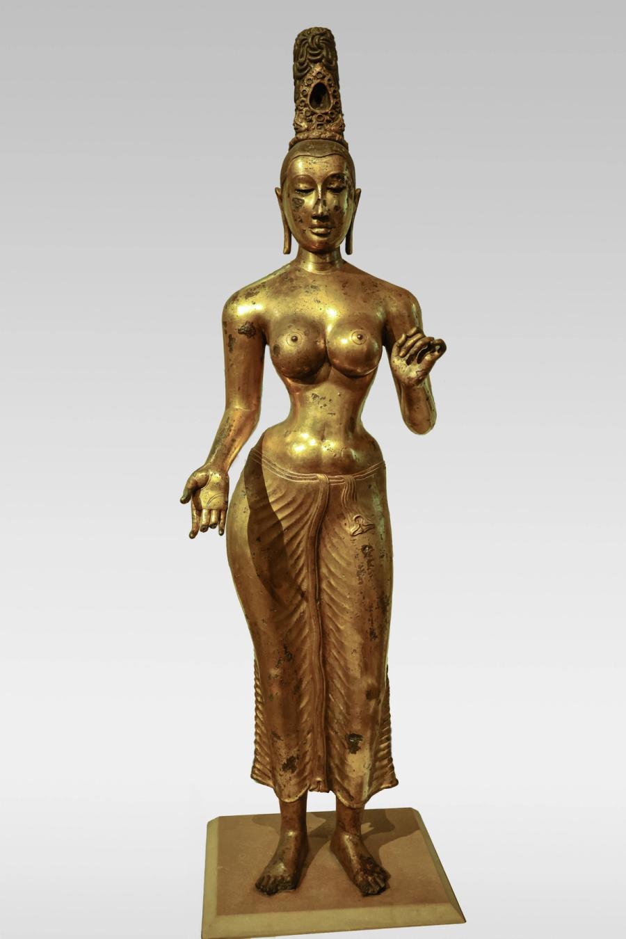 Gilded solid-bronze standing figure of the goddess Tara with tall jatamukuta crown.