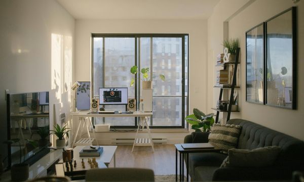 Modern apartment living room with sofa near glass window