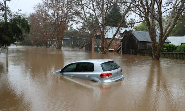 A car driving through a flooded street