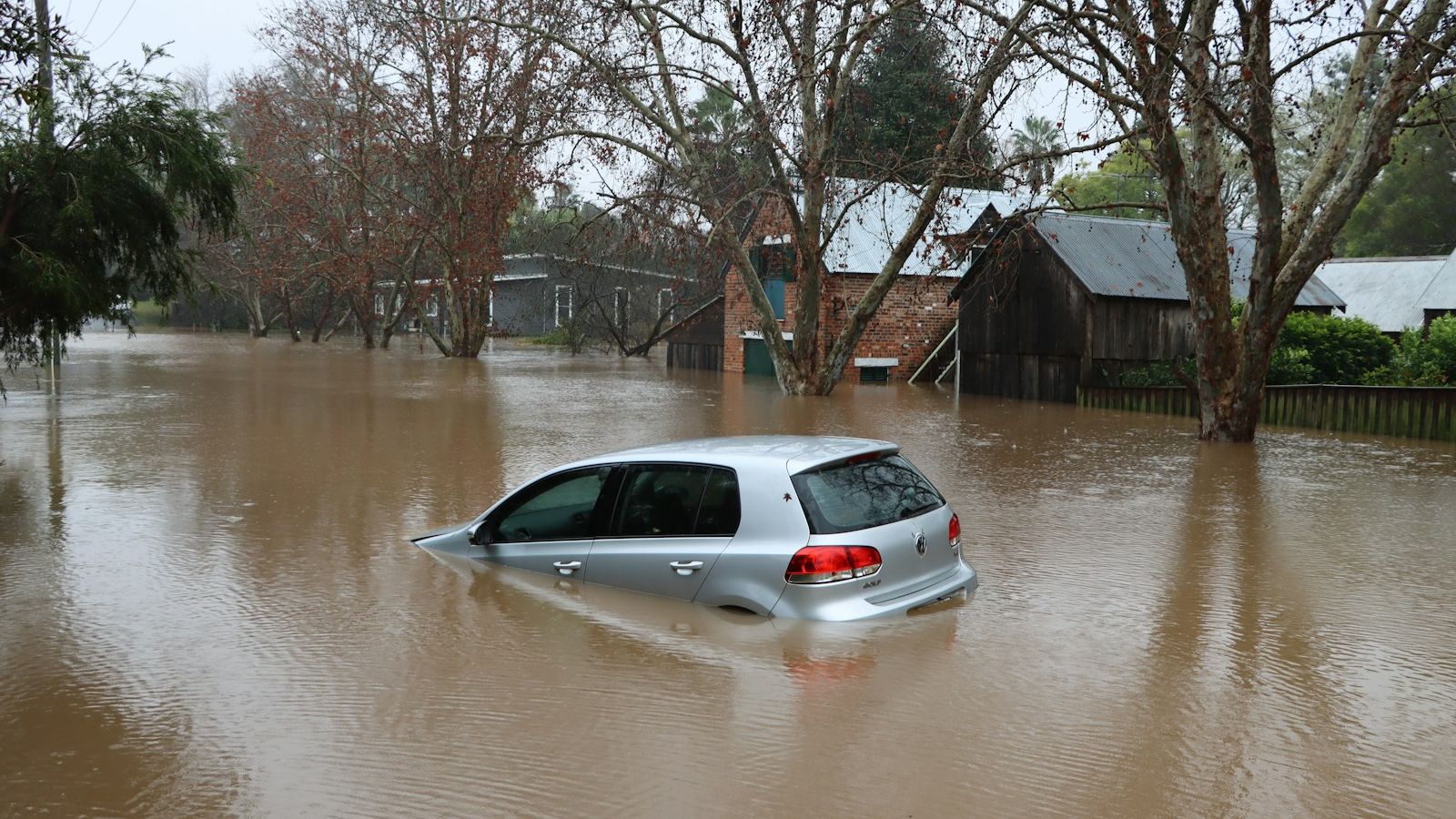 A car driving through a flooded street