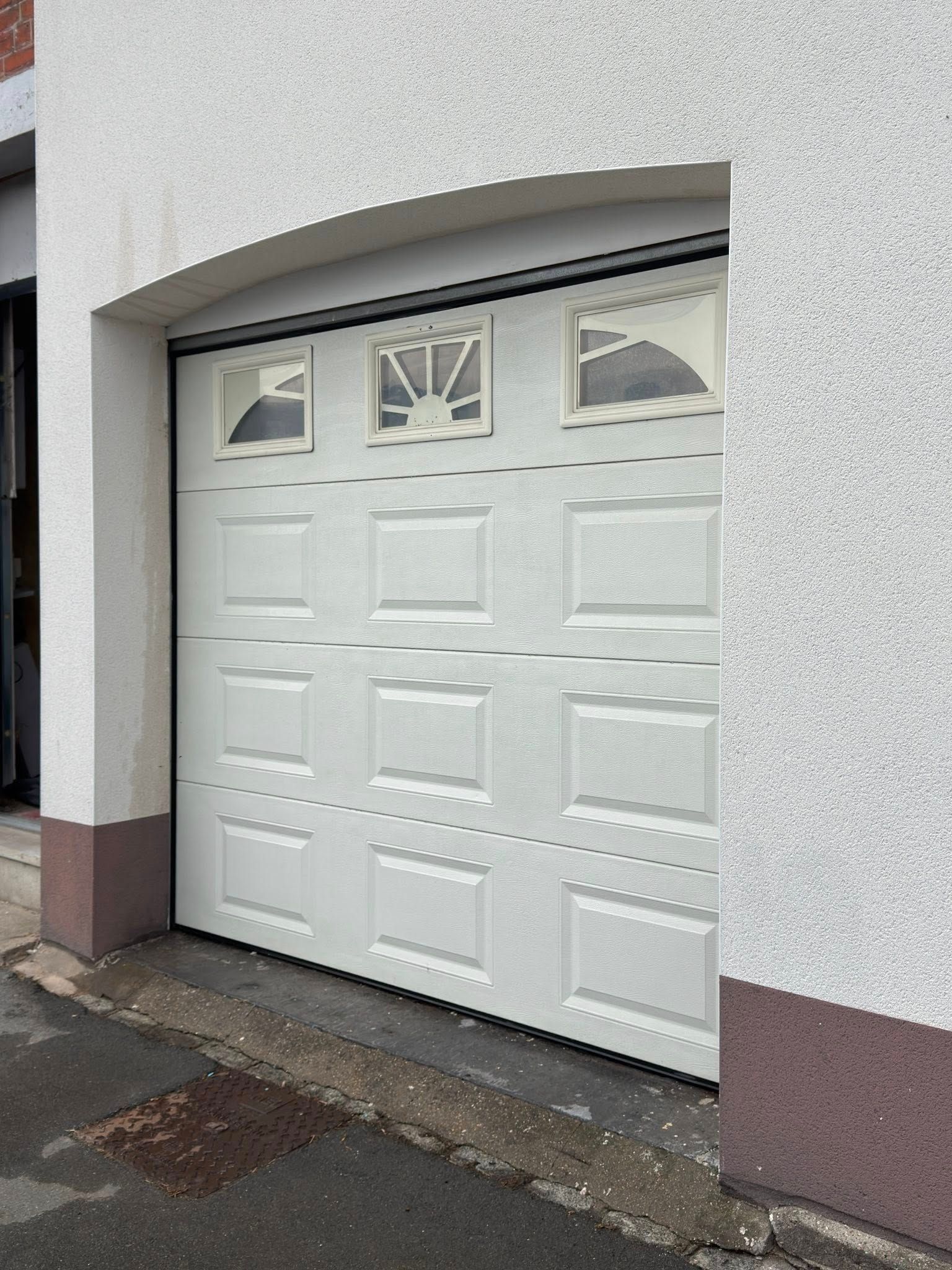 Porte de garage parfaitement propre et brillante après l'intervention de PAANDAWLV à Wattrelos