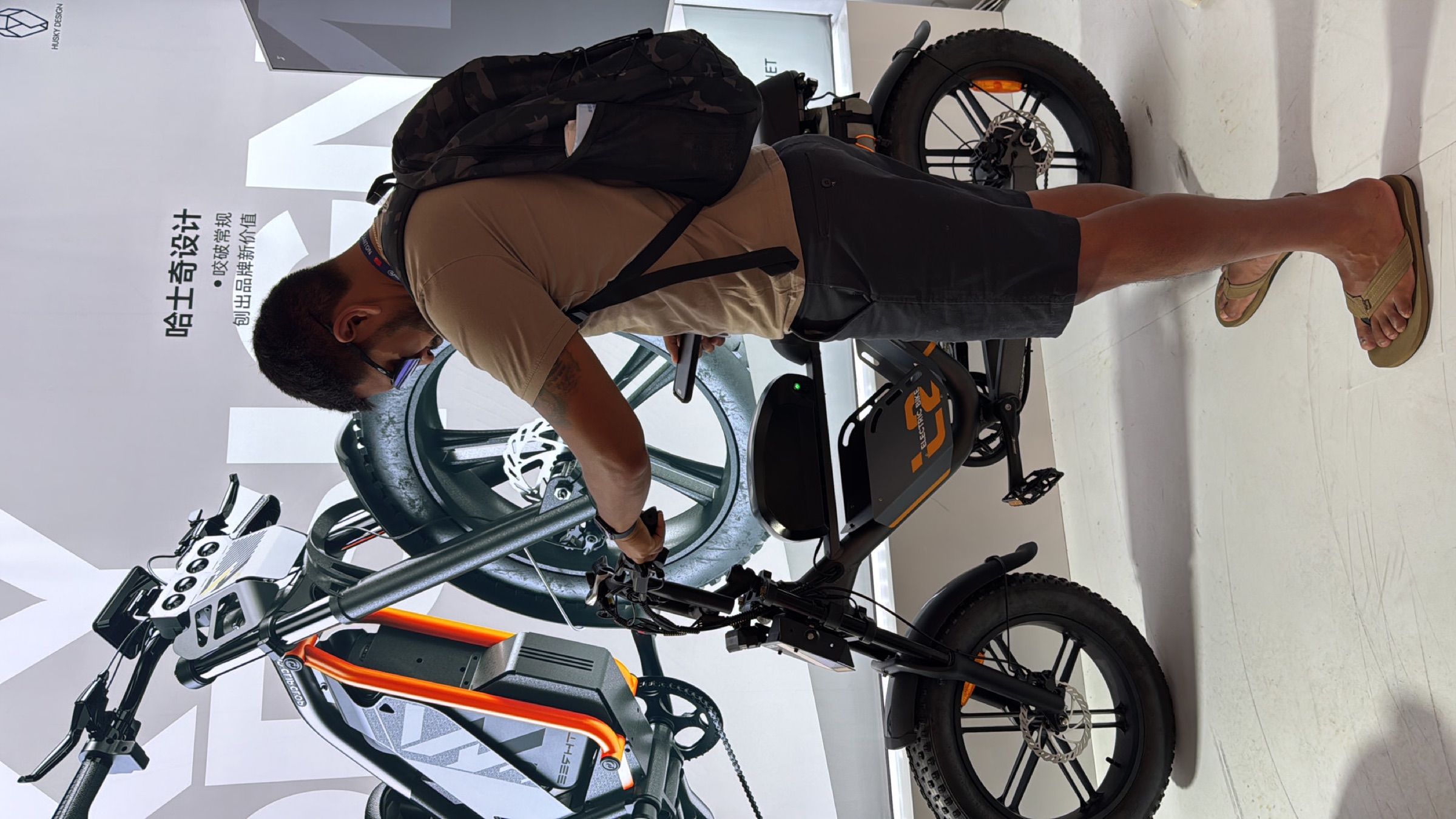 Buyer inspecting a ClipClop e-bike on the booth floor
