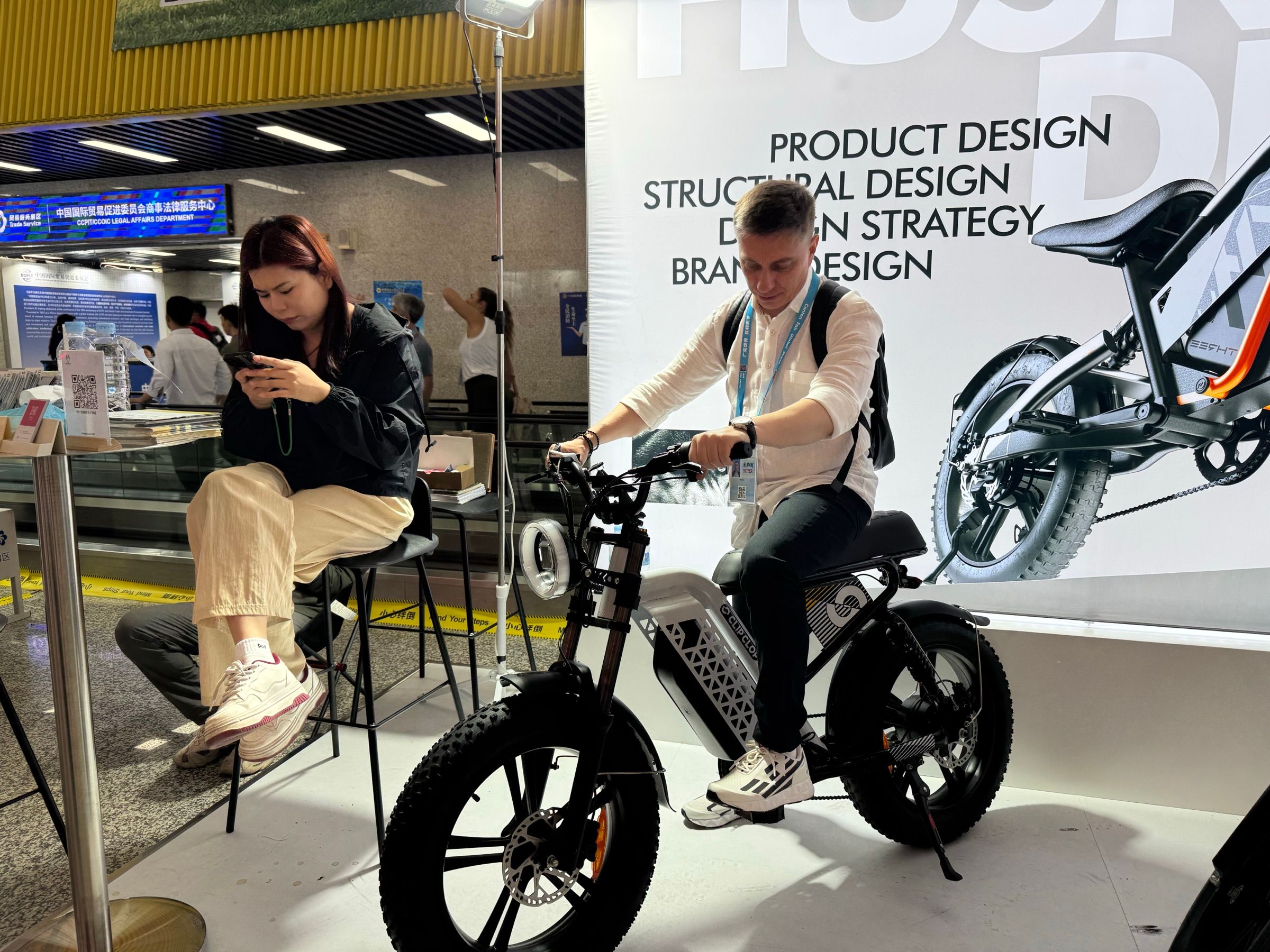 Visitor riding a ClipClop e-bike at booth BP104
