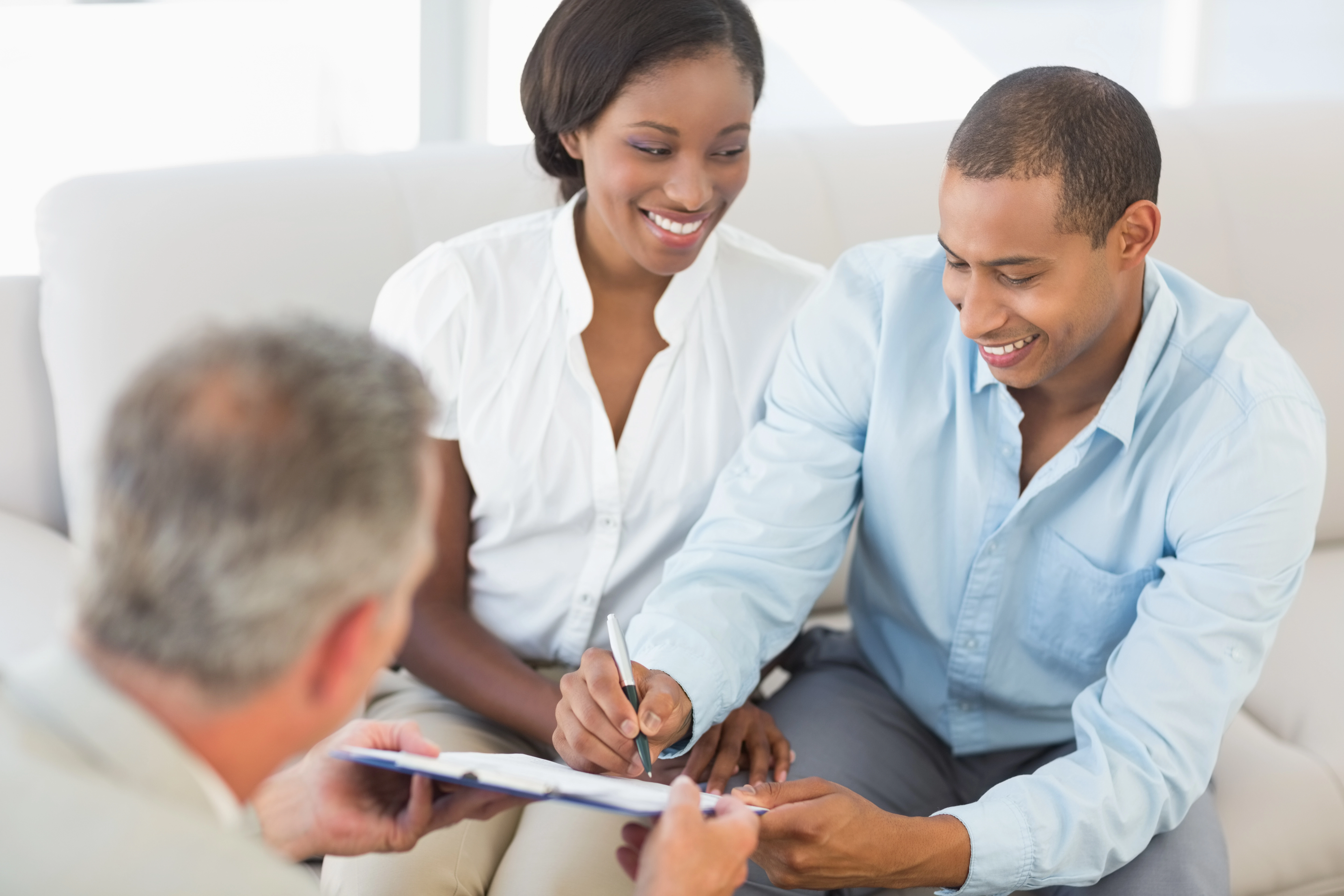 Home buyers signing mortgage documents.