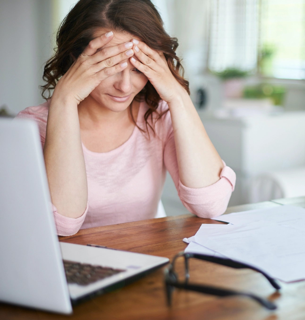 Worried woman considering on applying for mortgage forbearance.