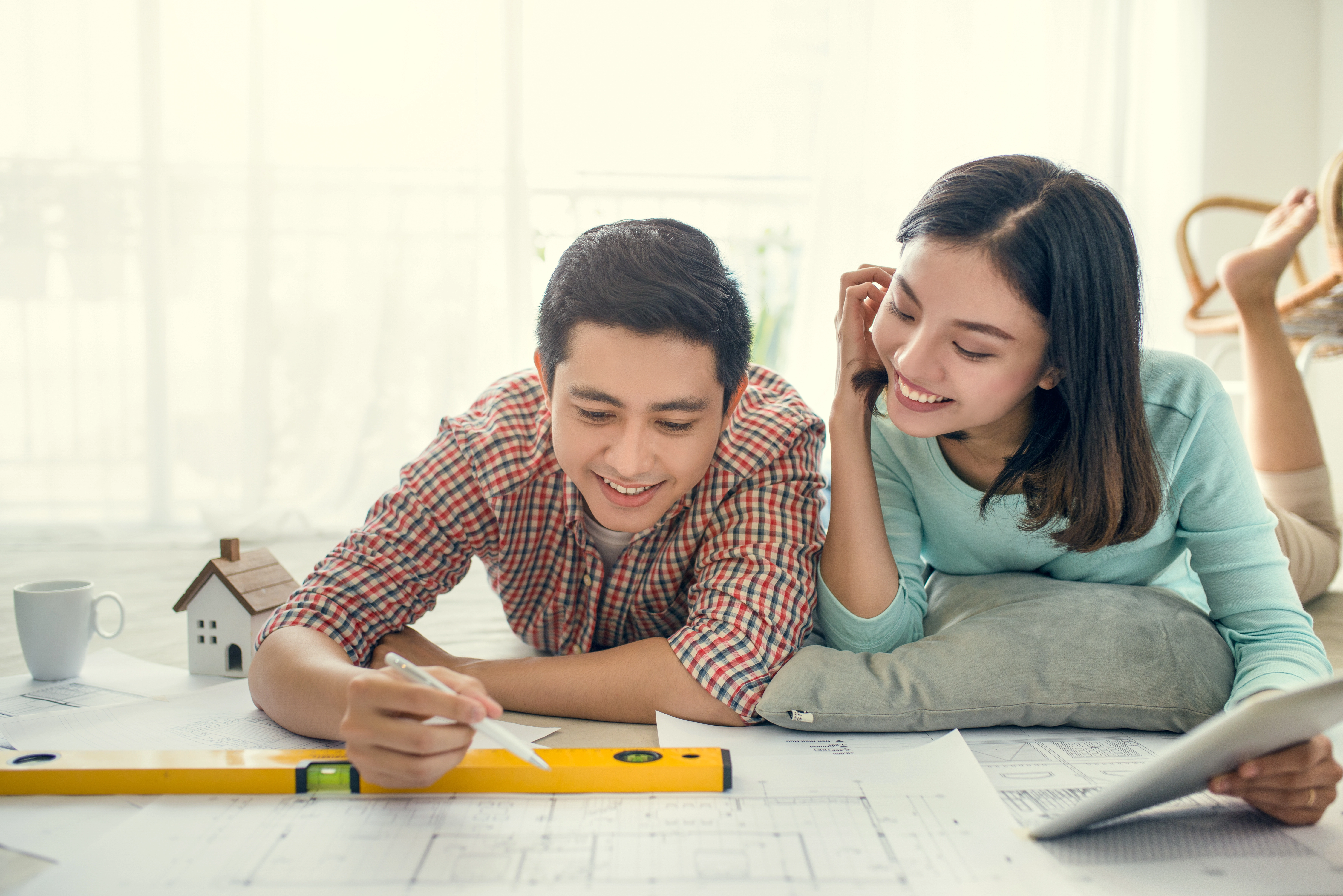 Young couple looking at home renovation plan.