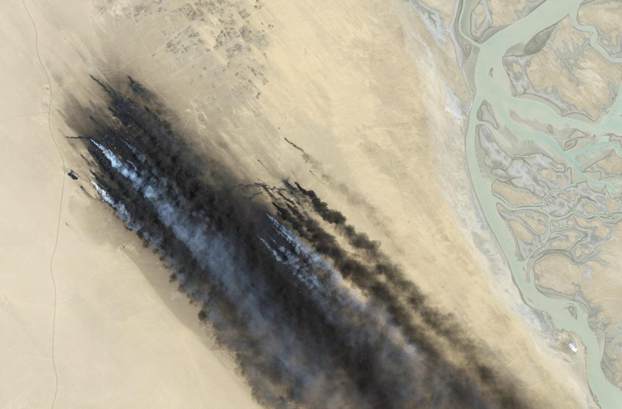 Data from USGS/NASA, processing by Planet • Smoke from burning oil wells in Kuwait • July 1, 1991