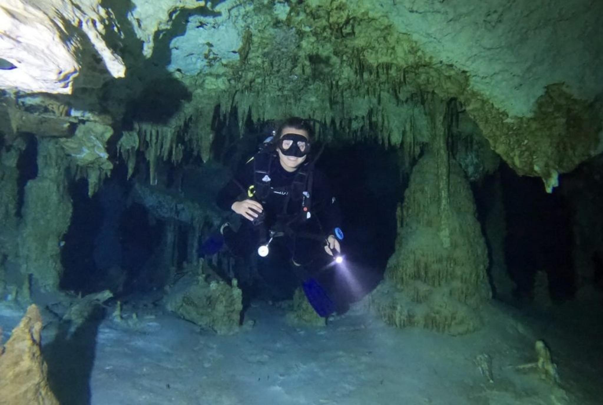 Amber scuba diving in a cenote in Tulum, Mexico