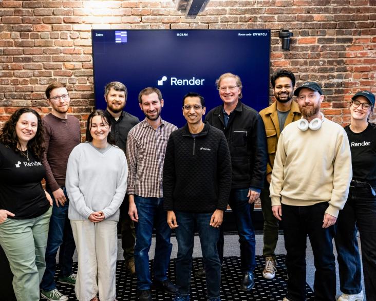 group of colleagues in front of a brick wall