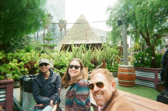 three coworkers taking a selfie in a garden