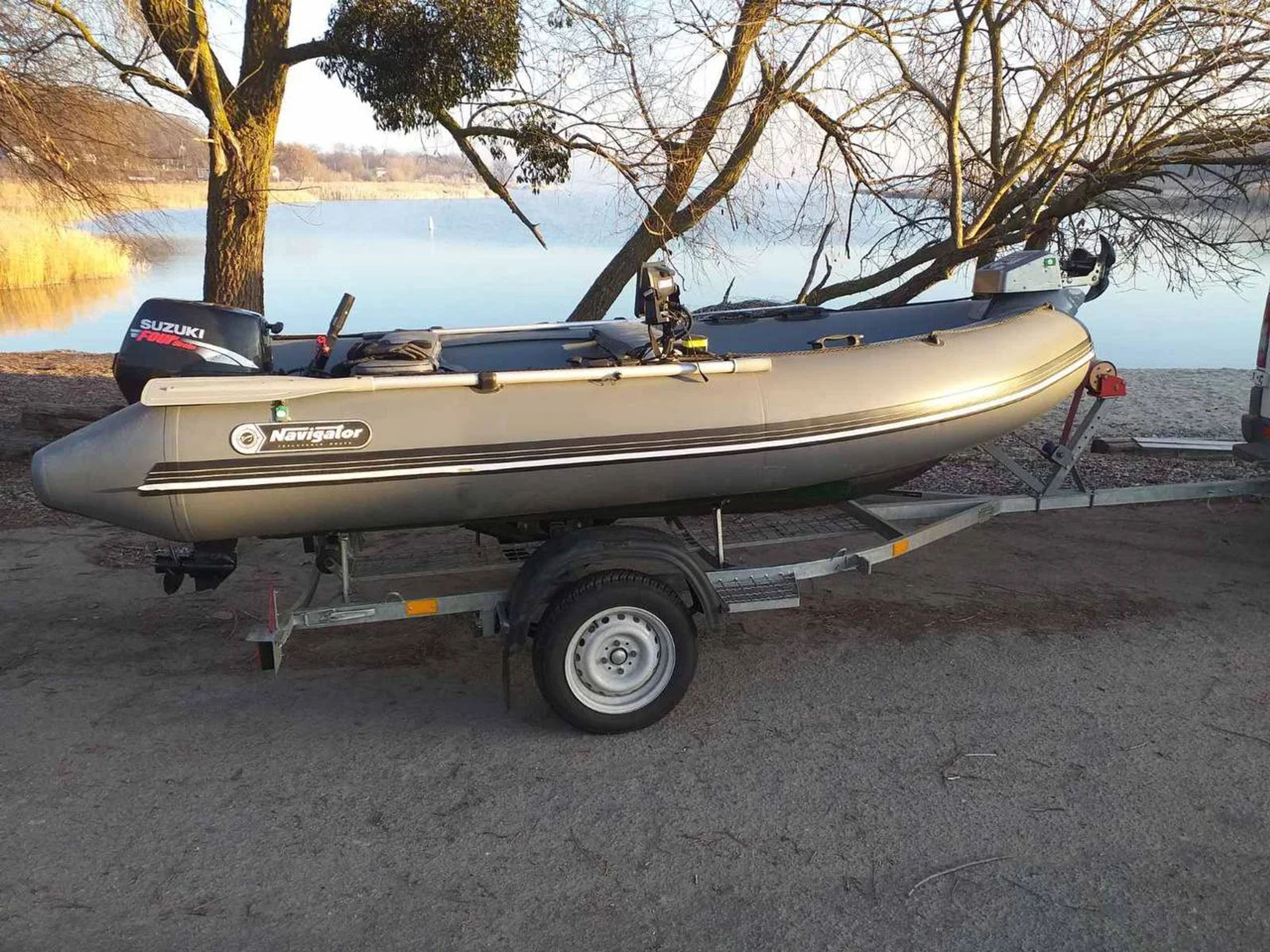 Boat on a single-axle trailer — trailer length and width decide which container it fits