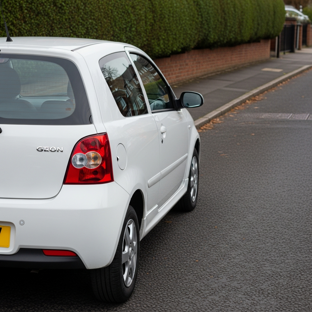 A small hatchback parked on a quiet residential street - low insurance group cars are a sensible first choice for learners.