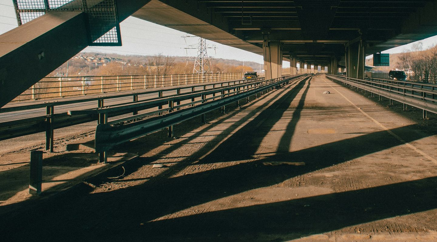 Looking up under a concrete motorway viaduct - bridge height limit uk
