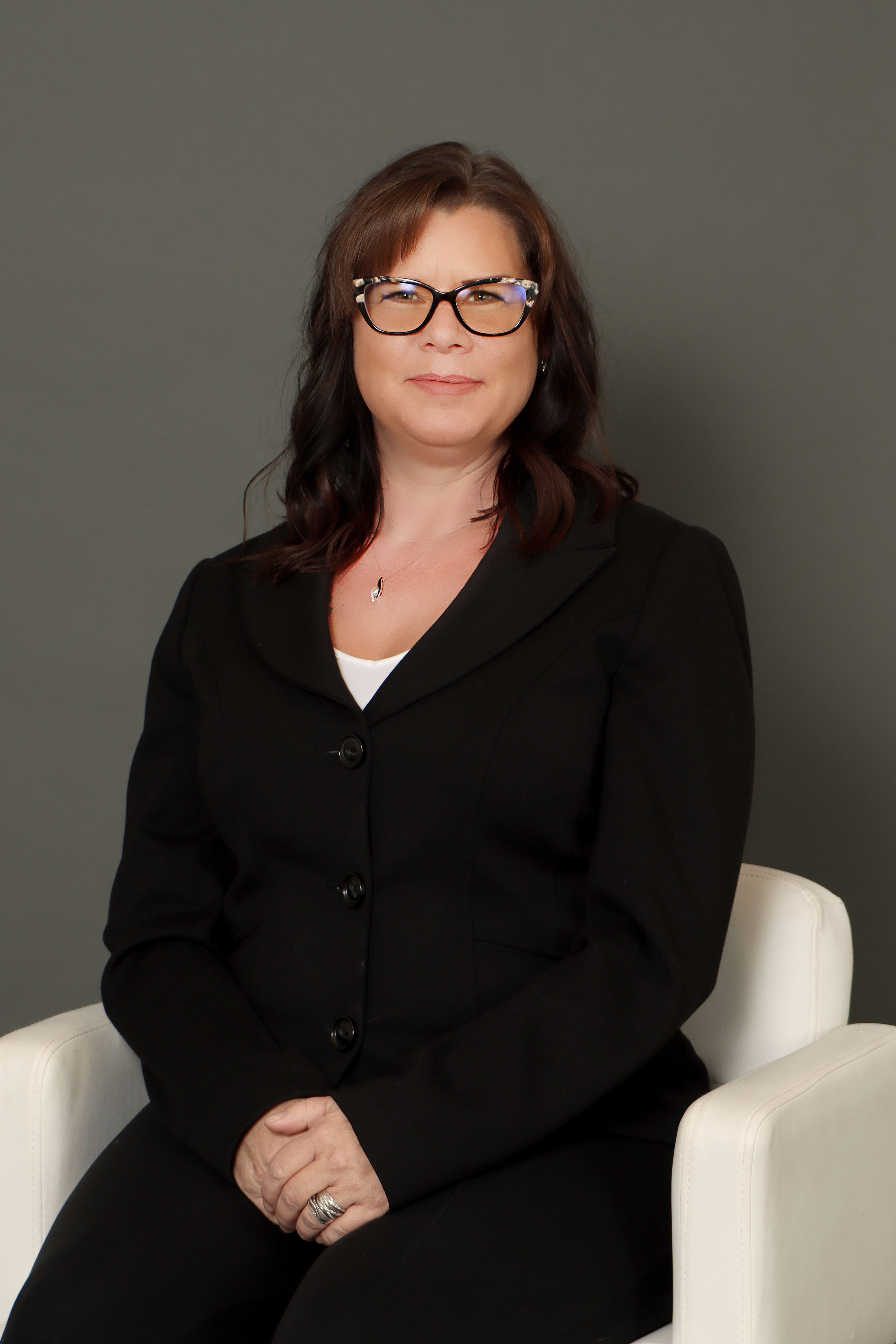 Kelli Smith headshot on a dark background