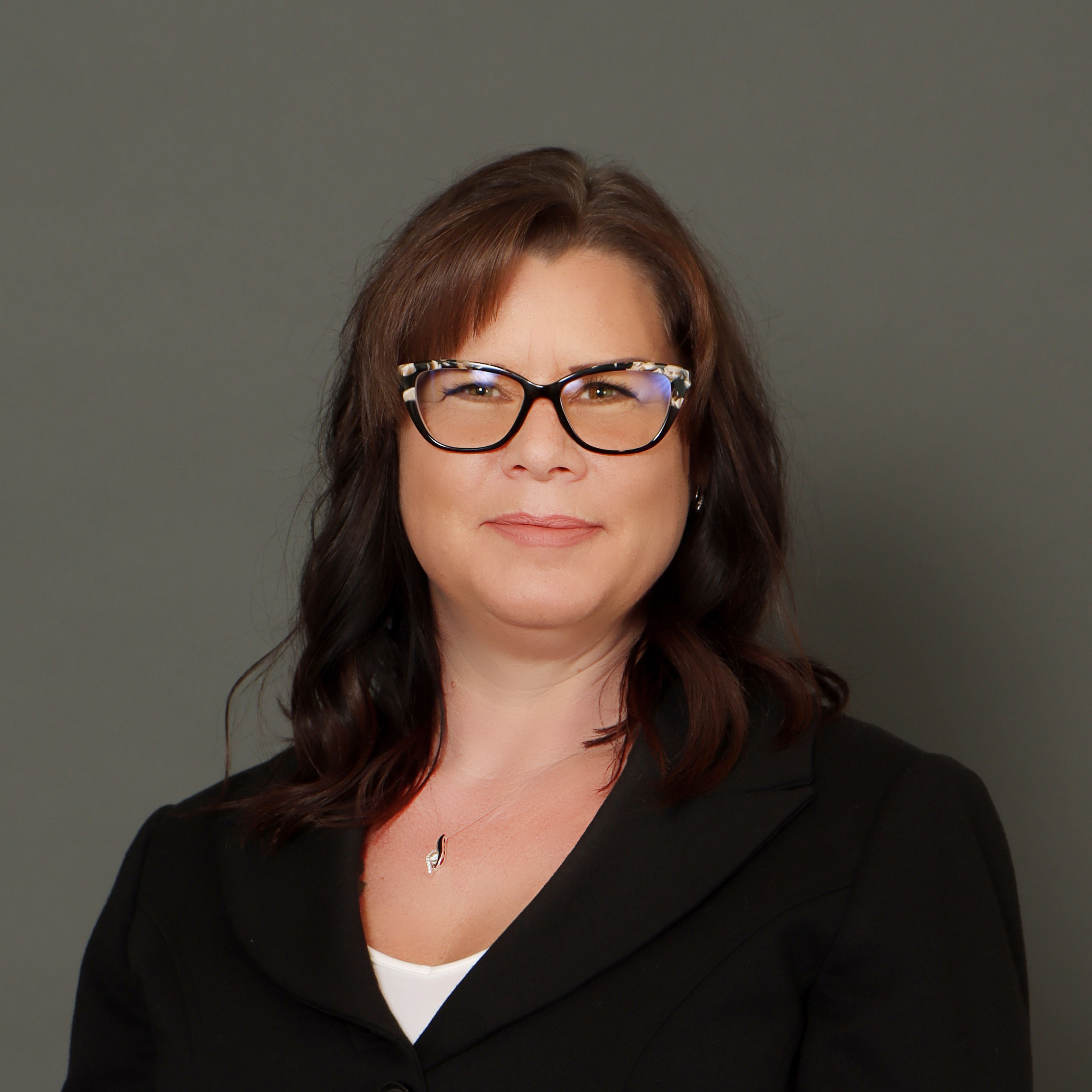 Kelli Smith headshot on a dark background