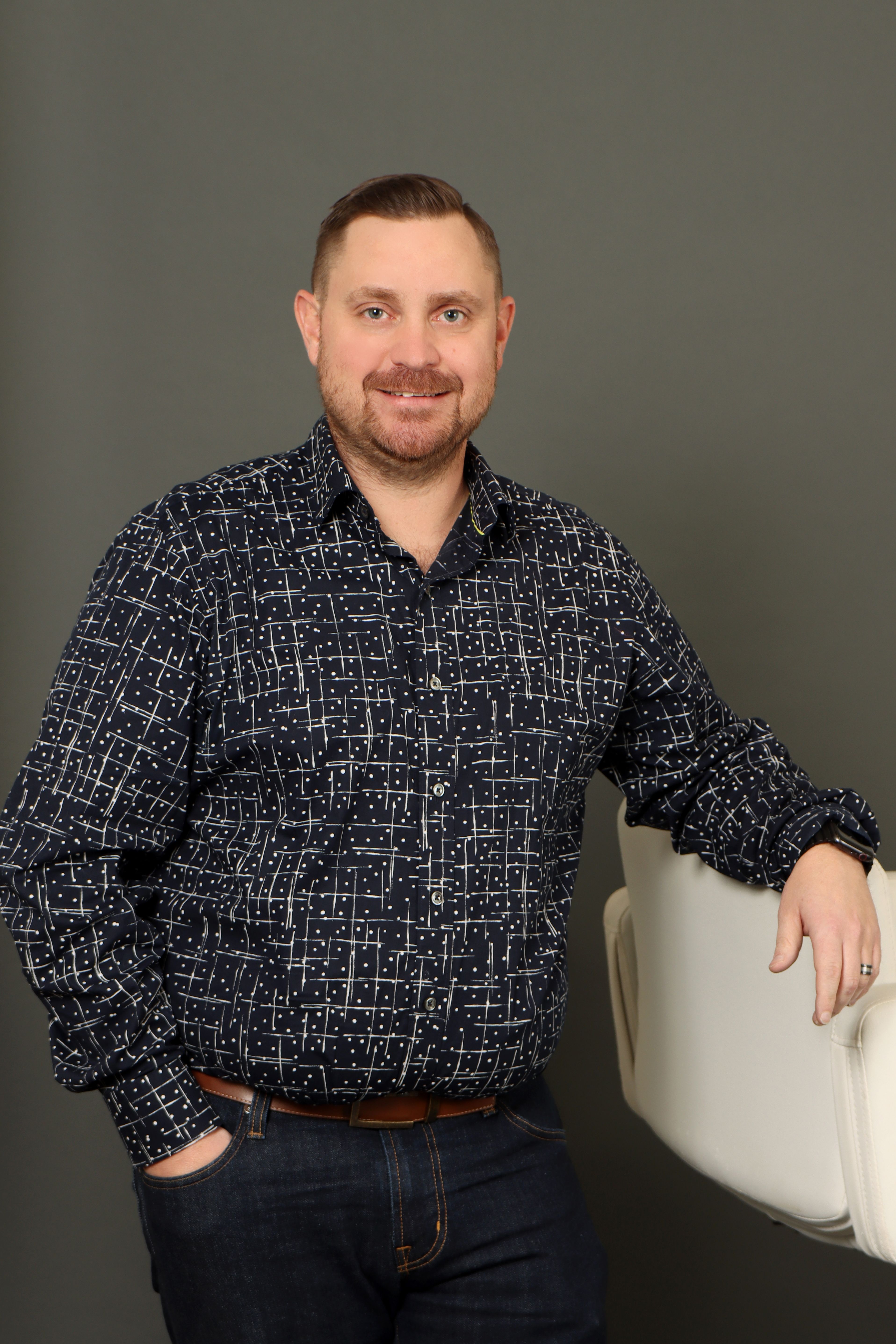 Adam Stepa headshot on a dark background