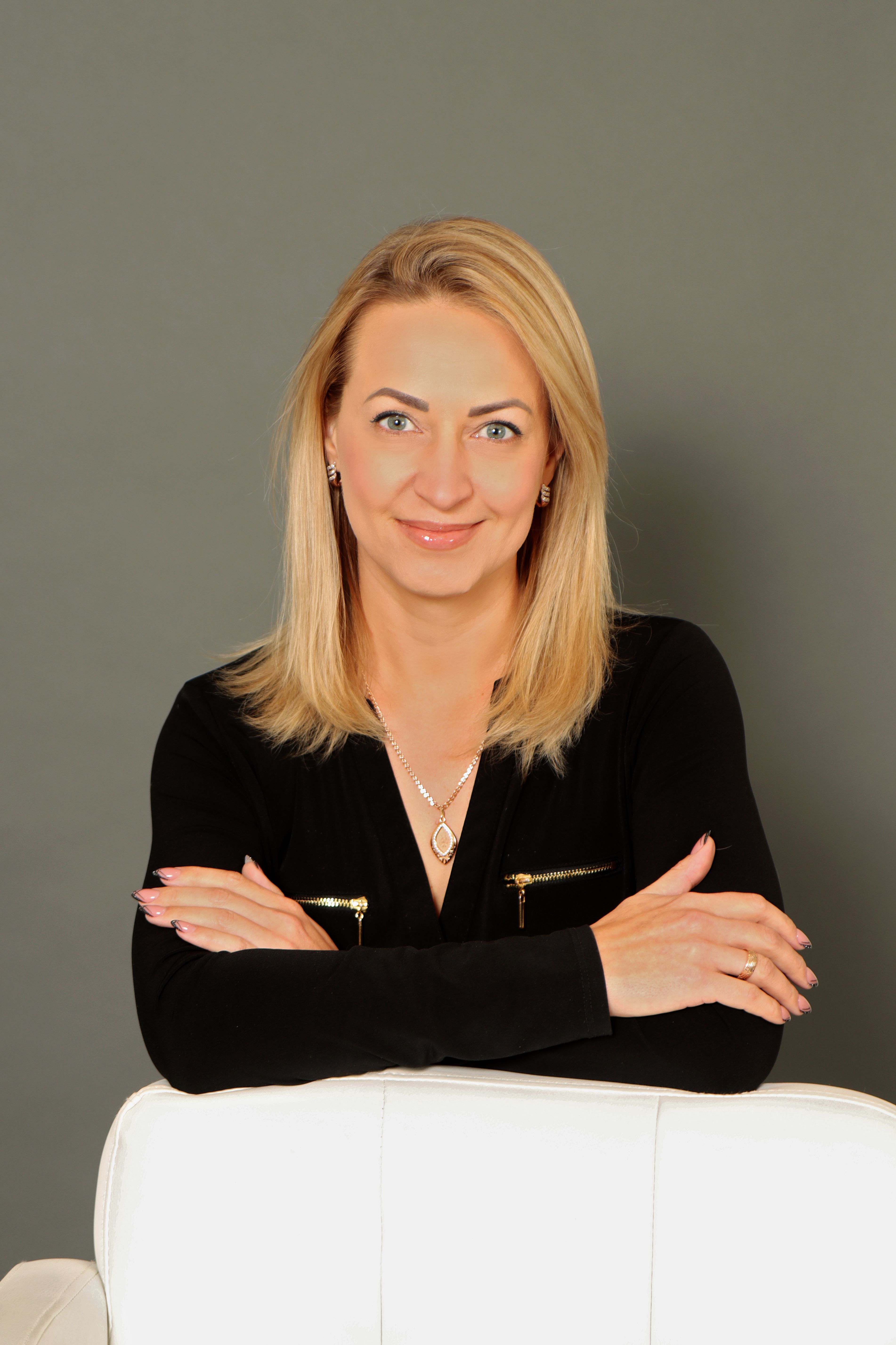 Anastasiya Mulyukina headshot on a dark background