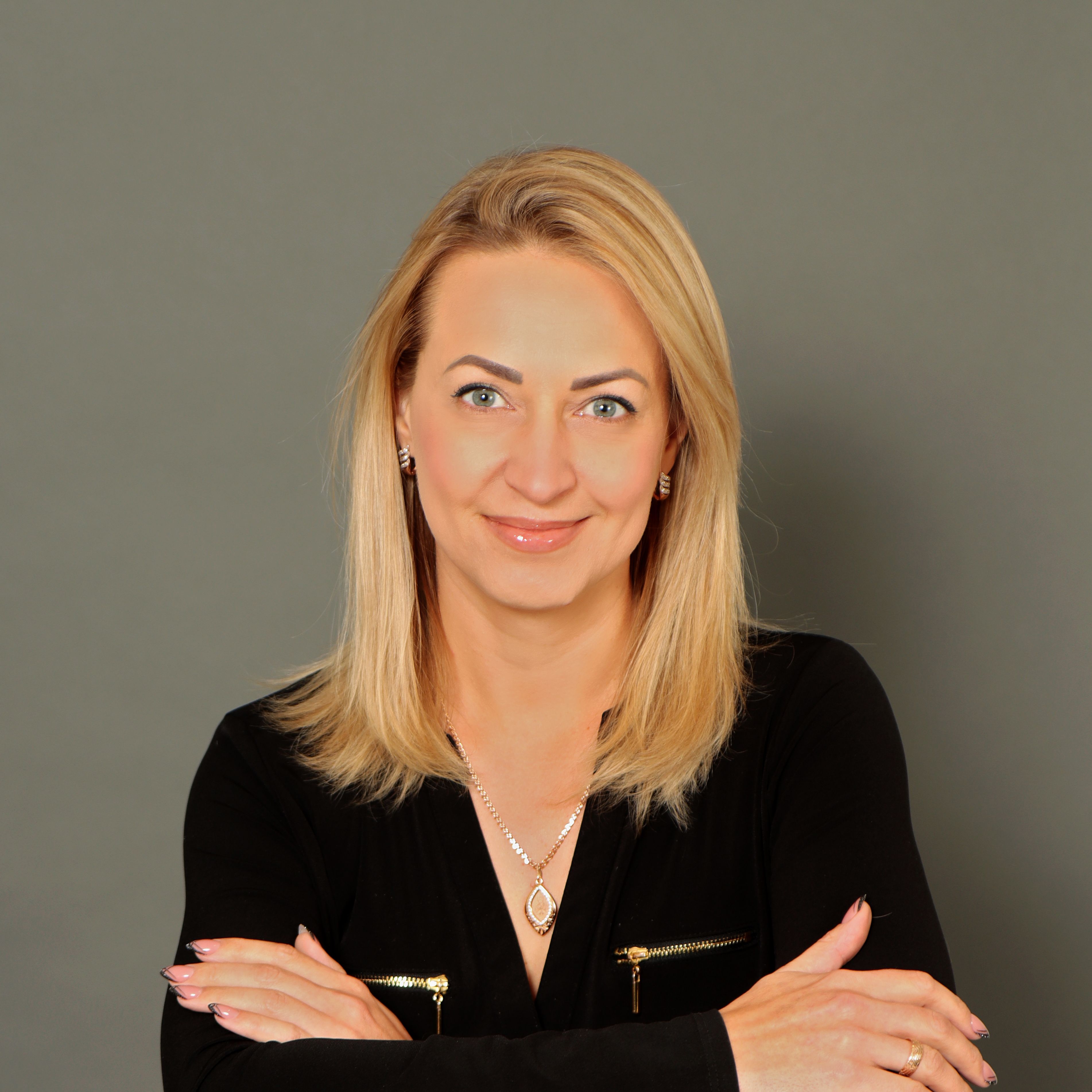 Anastasiya Mulyukina headshot on a dark background