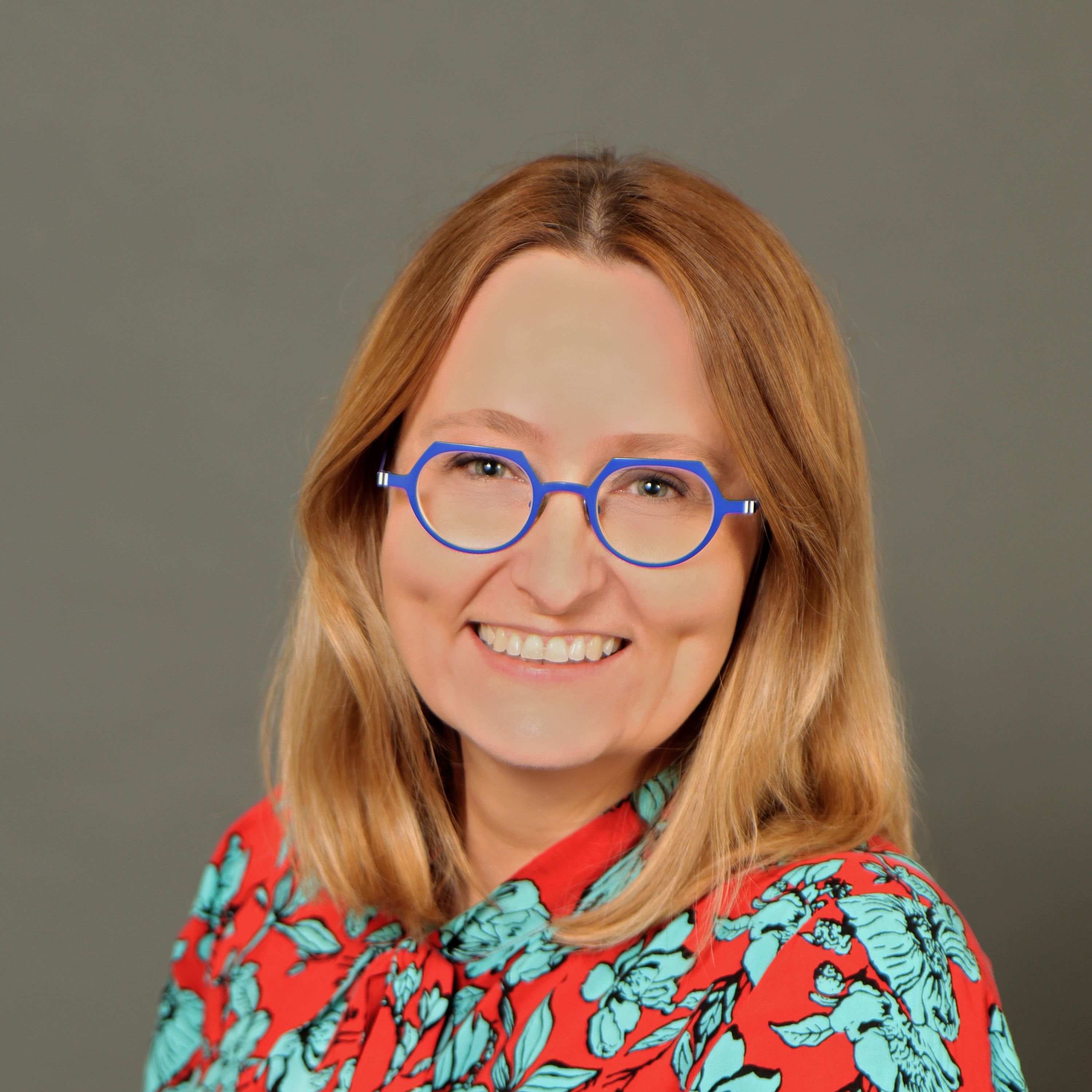 Marta Adamiuk headshot on a dark background