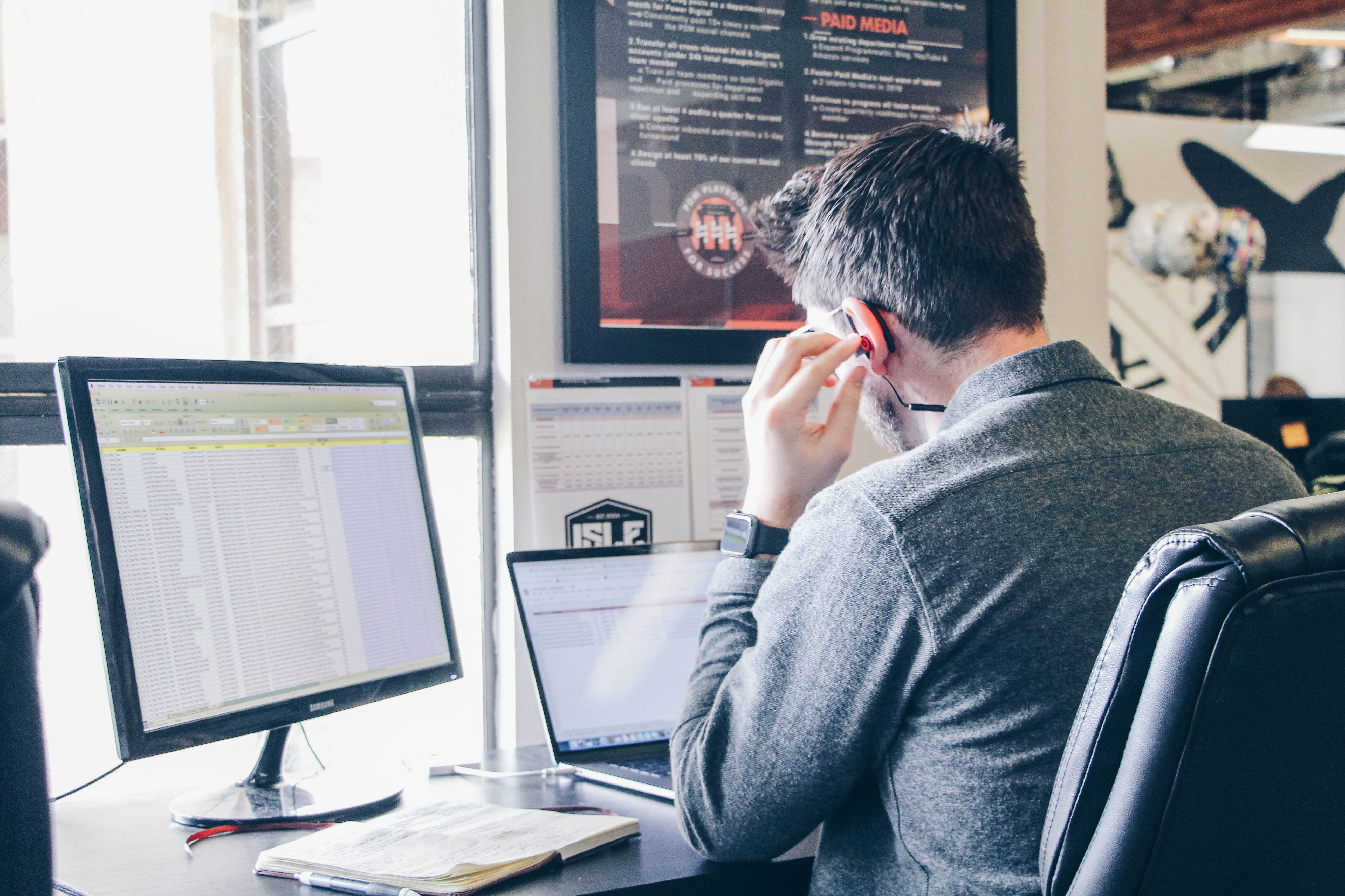 A worker views three separate spreadsheets at once while taking a call at work.