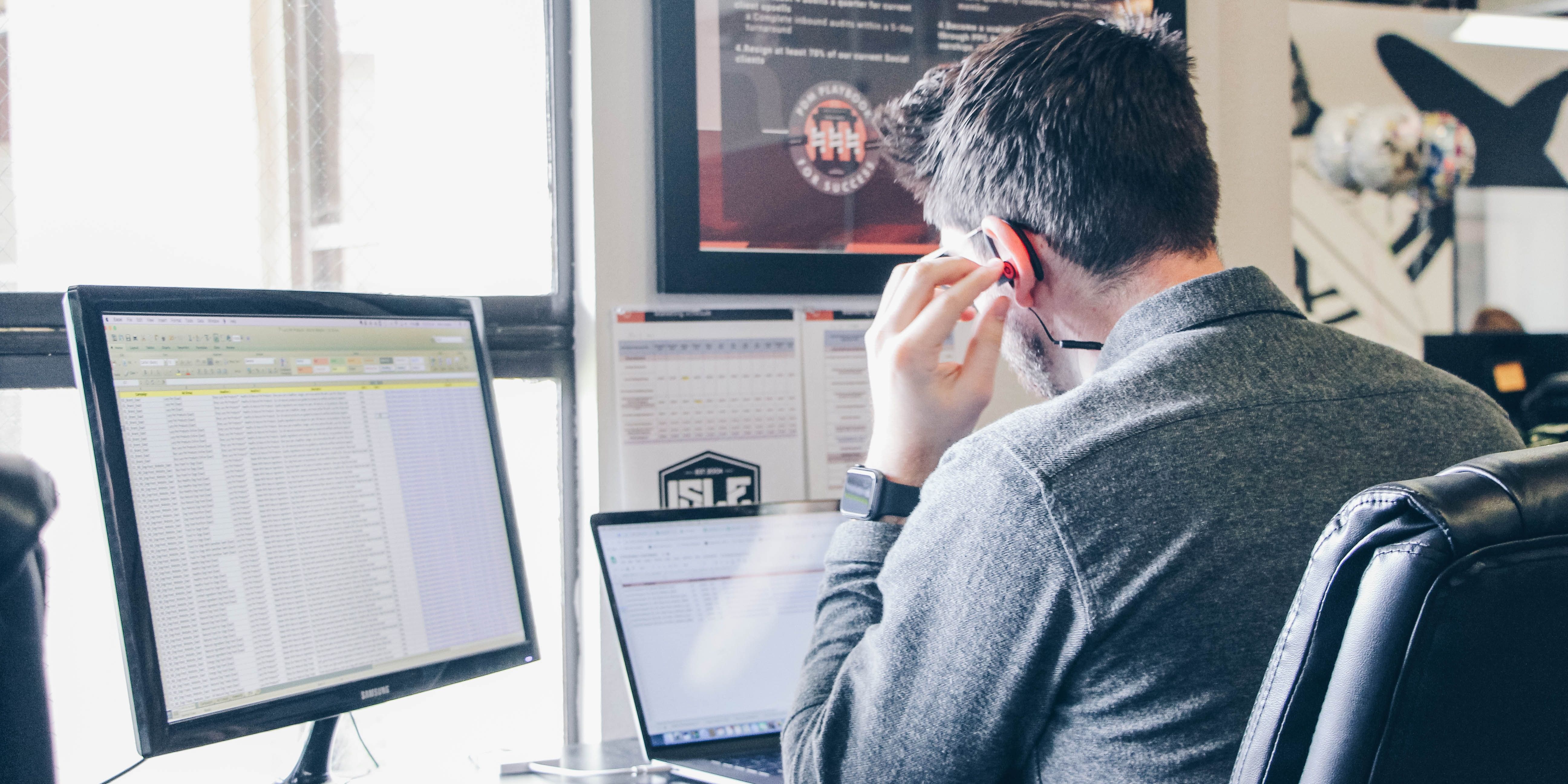 A worker views three separate spreadsheets at once while taking a call at work.