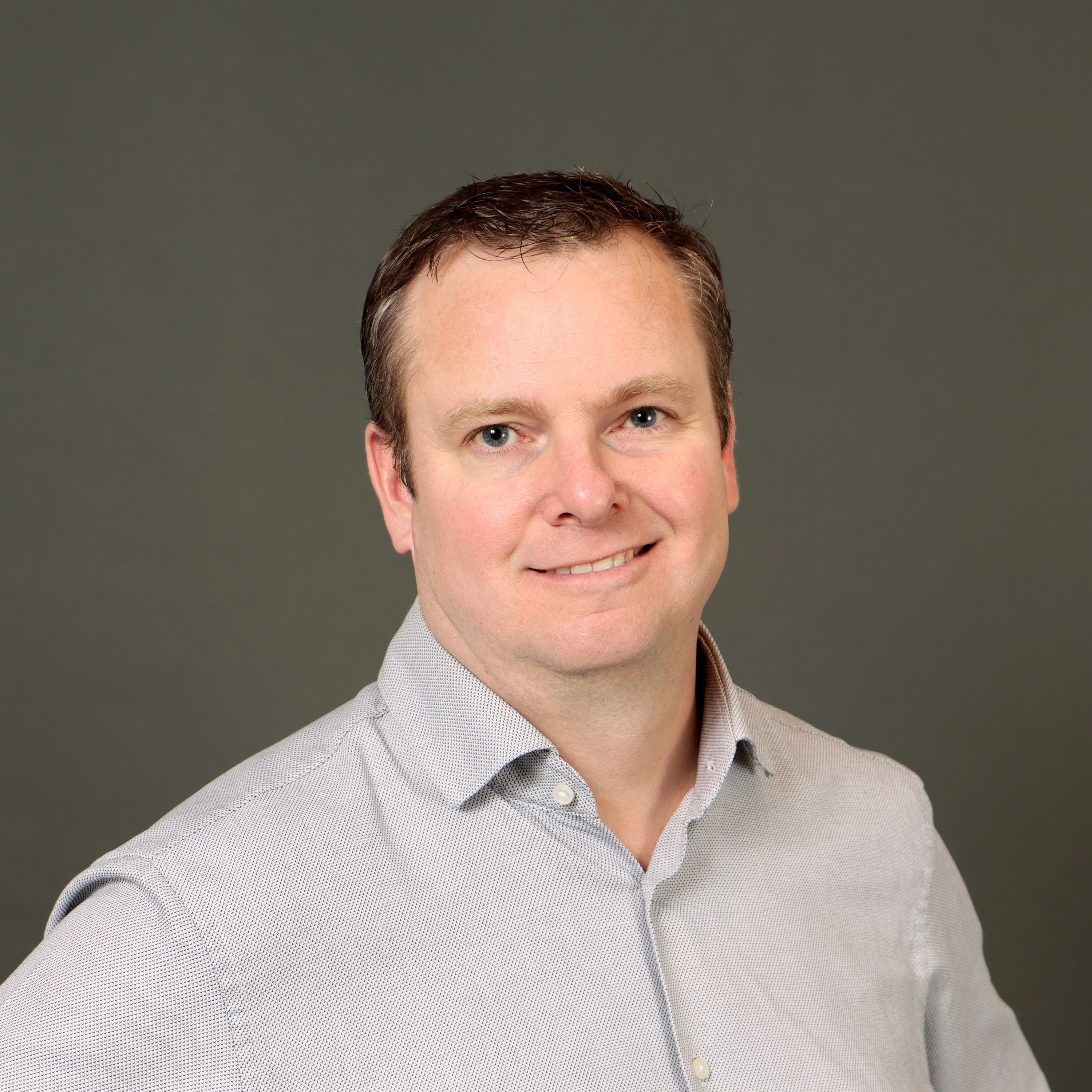 Kyle Jones headshot on a dark background