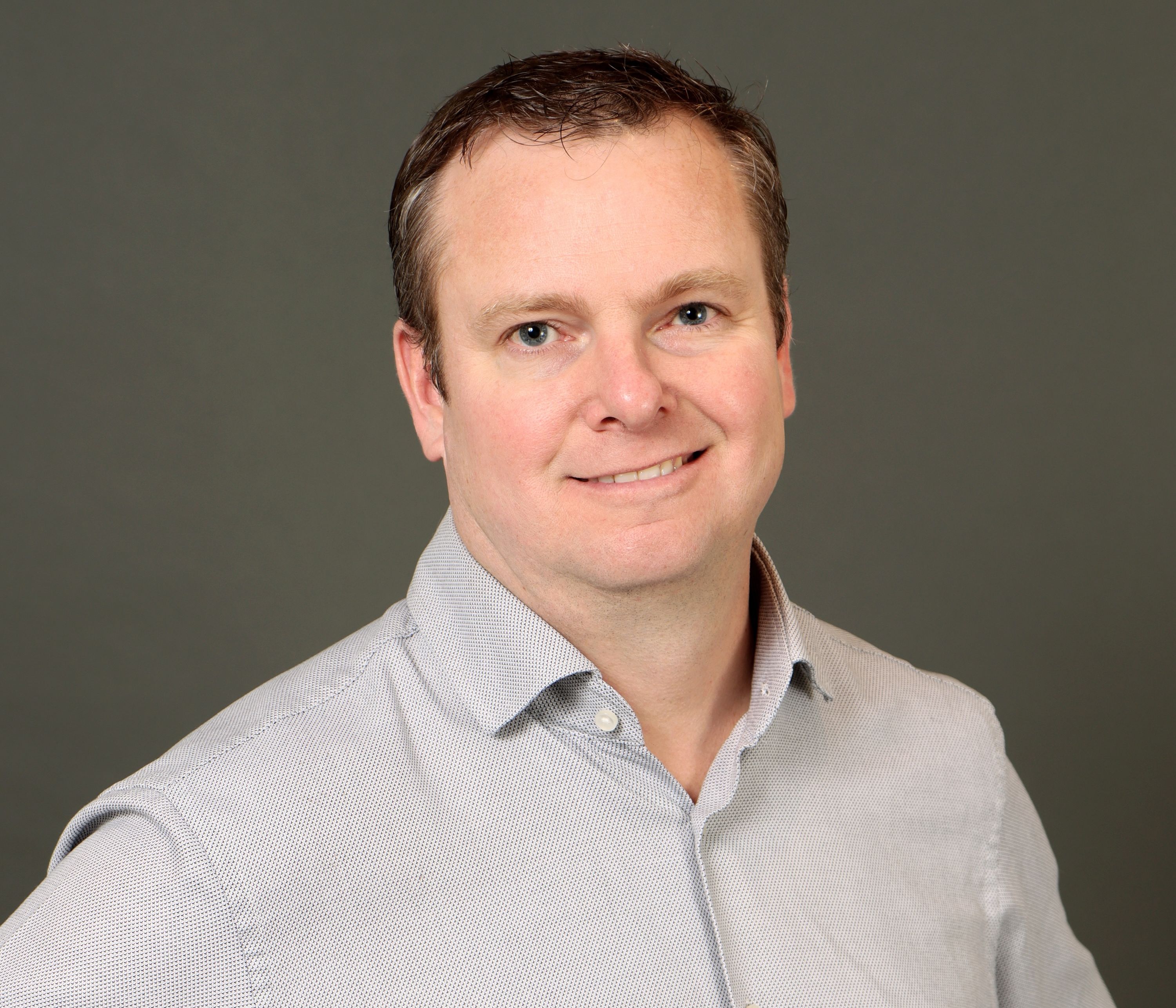 Kyle Jones headshot on a dark background