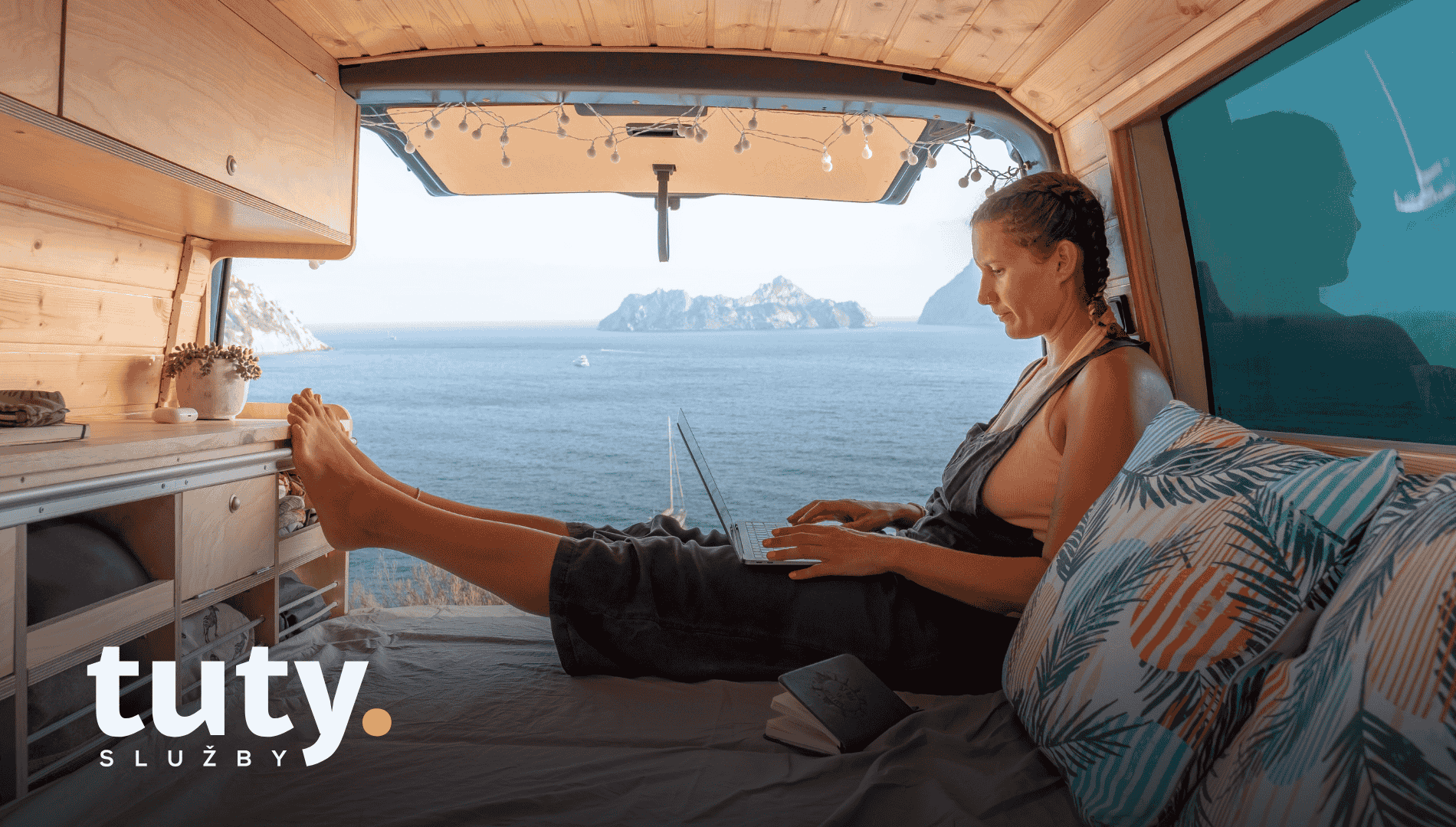 Žena pracuje na laptopu z upravené dodávky u moře.