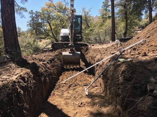 Excavator working on a septic installation site