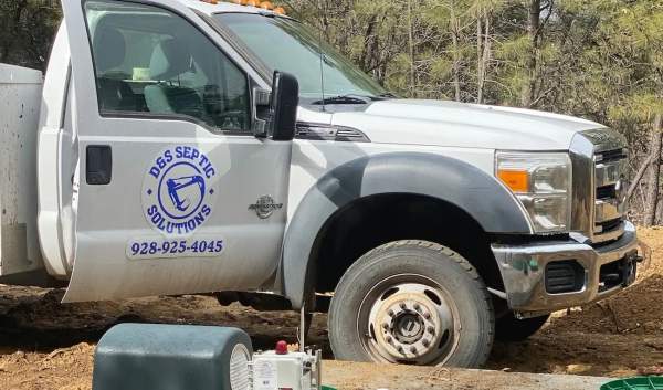 Branded D&S service truck at a septic job site